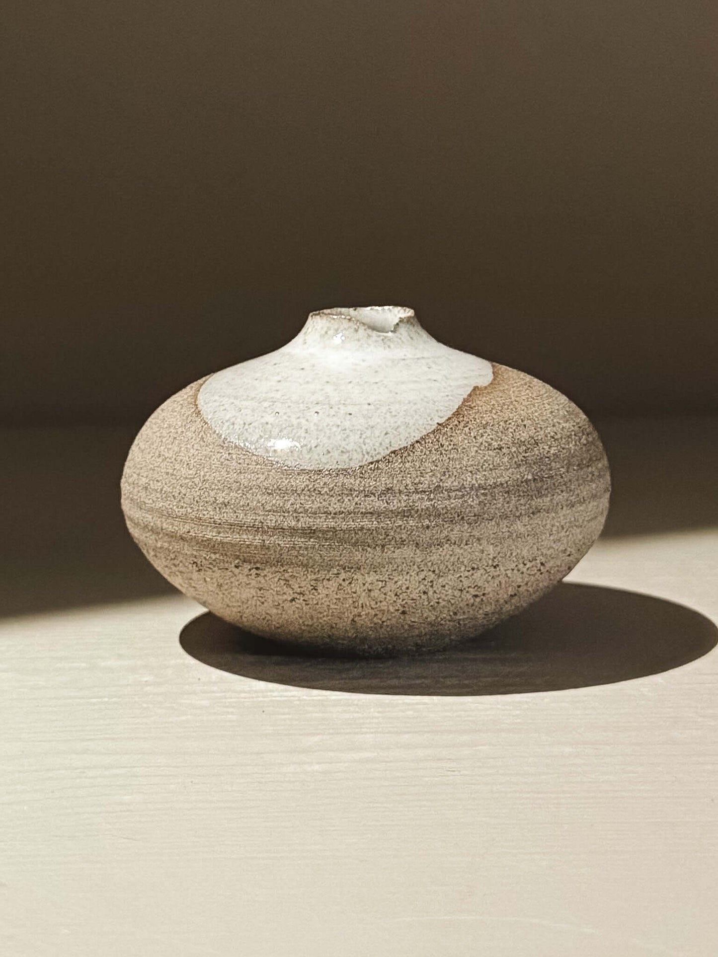 Handmade ceramic Japanese orb vase Orb Vase – Yuki Ash #13 with unique glaze patterns and soft rounded shape.