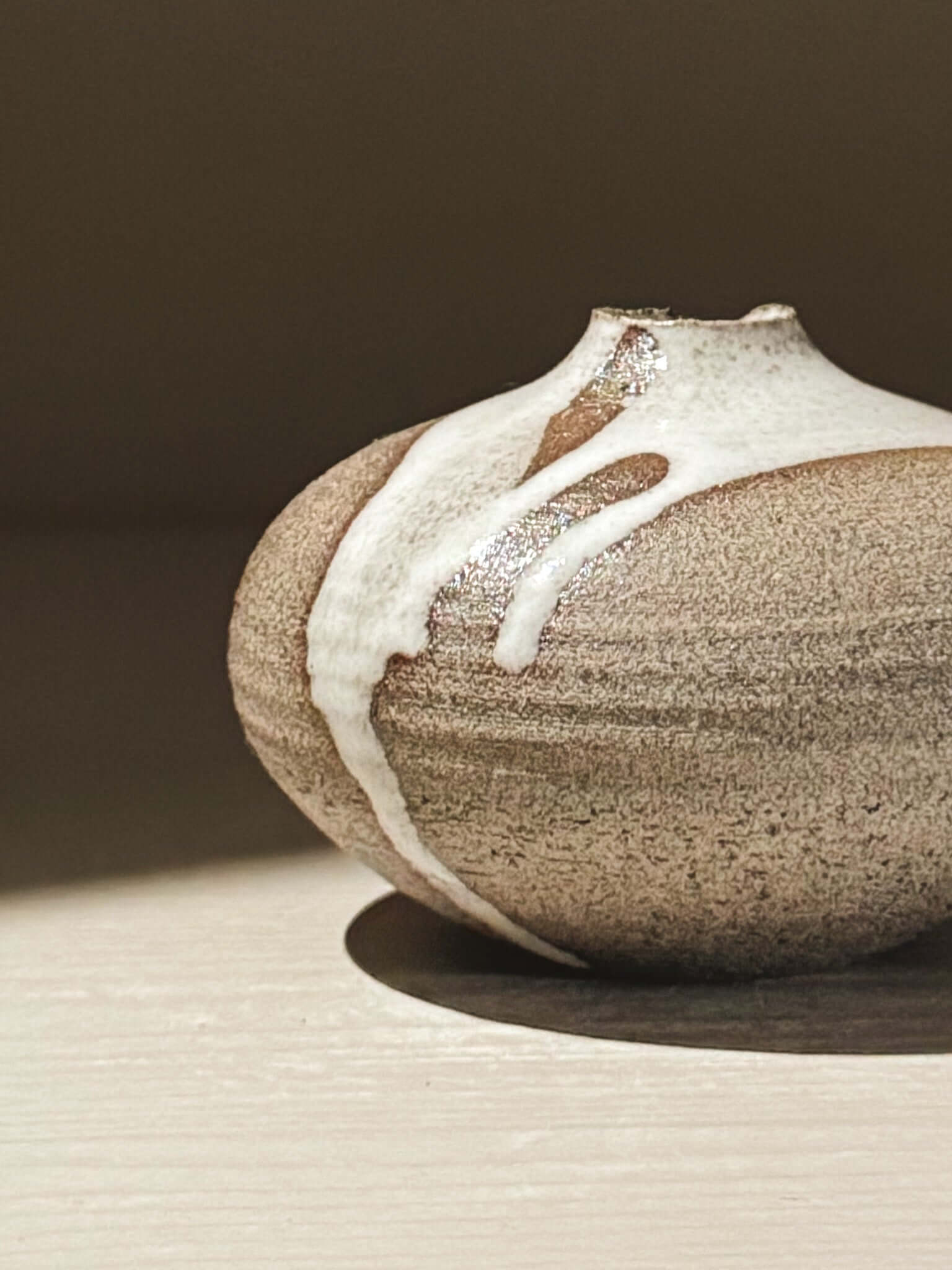 Handmade ceramic Japanese orb vase – Yuki Ash #13 showcasing unique glaze patterns and soft spherical form.