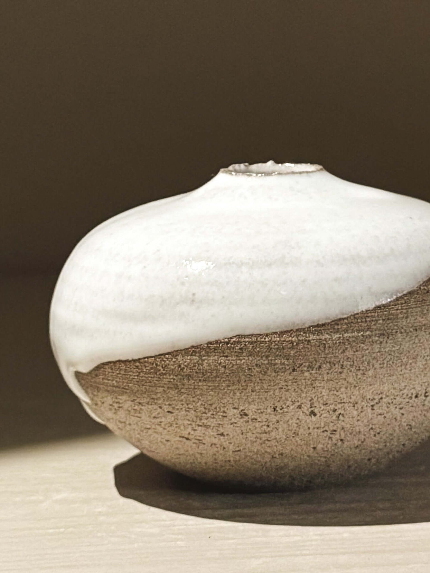 Handmade ceramic Japanese orb vase, Orb Vase – Yuki Ash #14, with unique glaze patterns and soft spherical form.