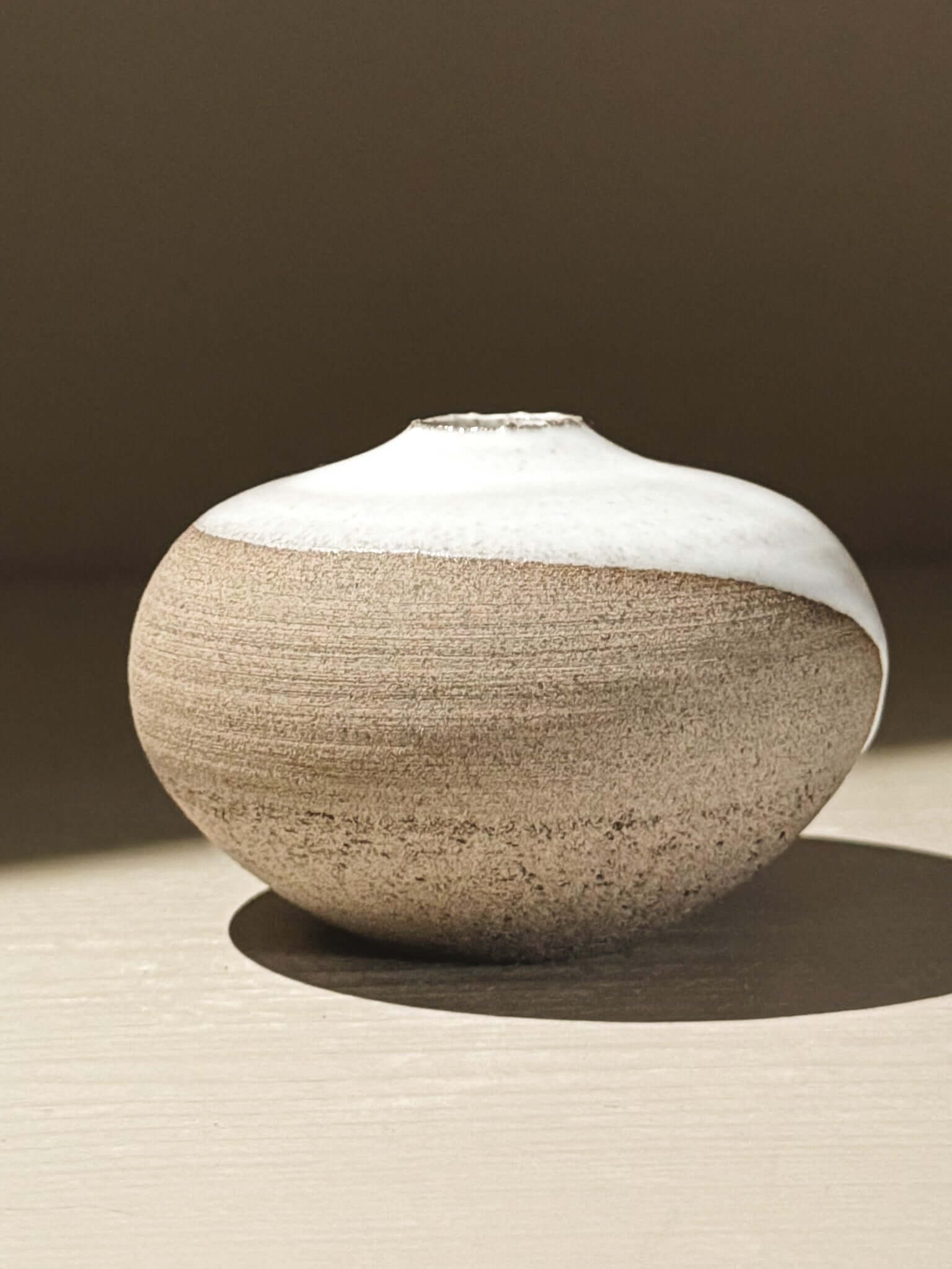 Orb Vase – Yuki Ash #14 handmade ceramic japanese orb vase with a unique glaze pattern and soft spherical form.