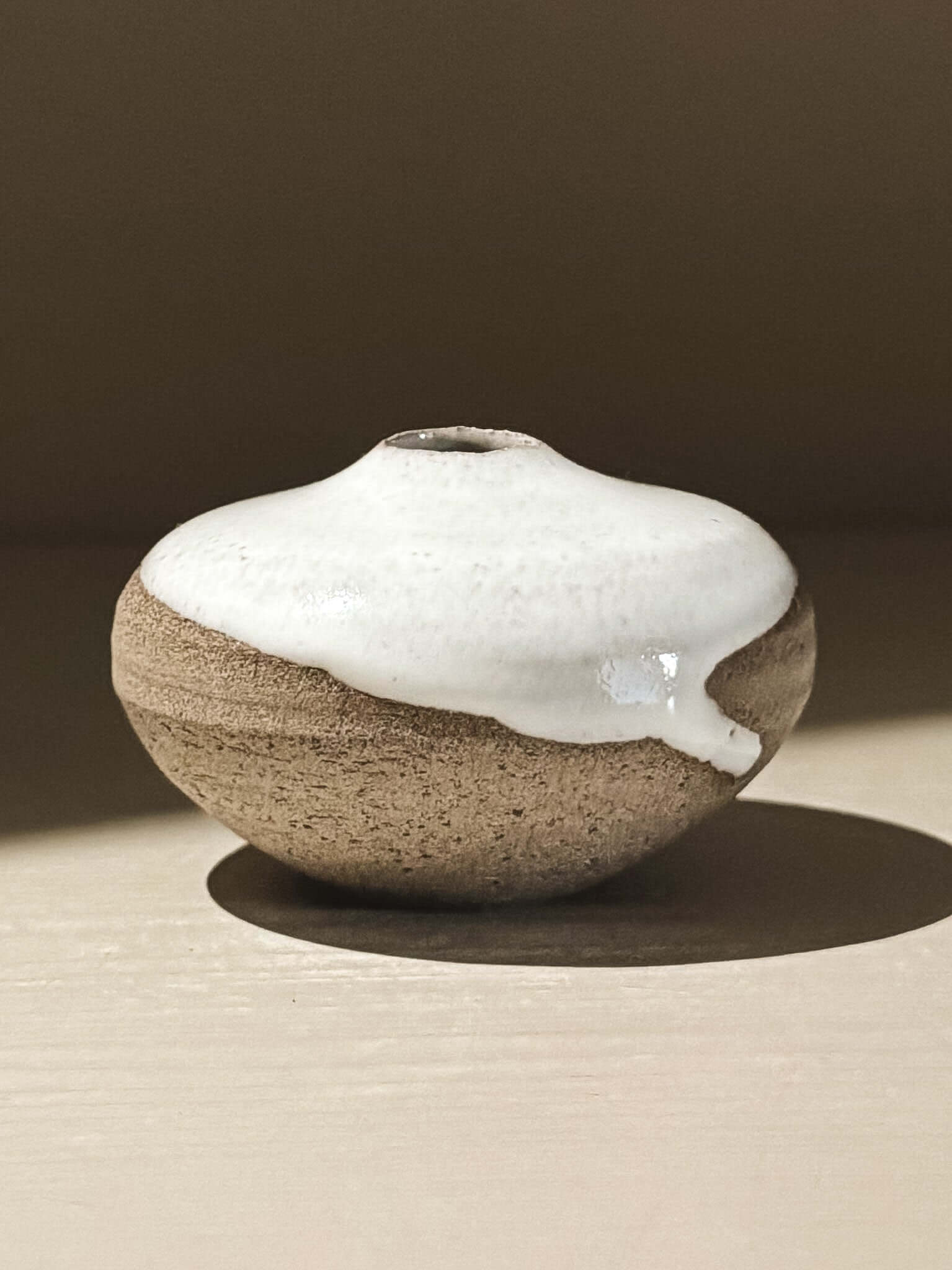 Handmade ceramic Japanese Orb Vase – Yuki Ash #15 featuring unique glaze patterns and soft spherical form.