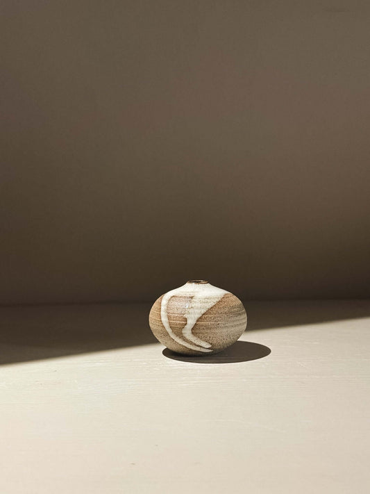 Handmade ceramic Japanese orb vase, Orb Vase – Yuki Ash #16, showcasing unique glaze patterns and soft spherical form.