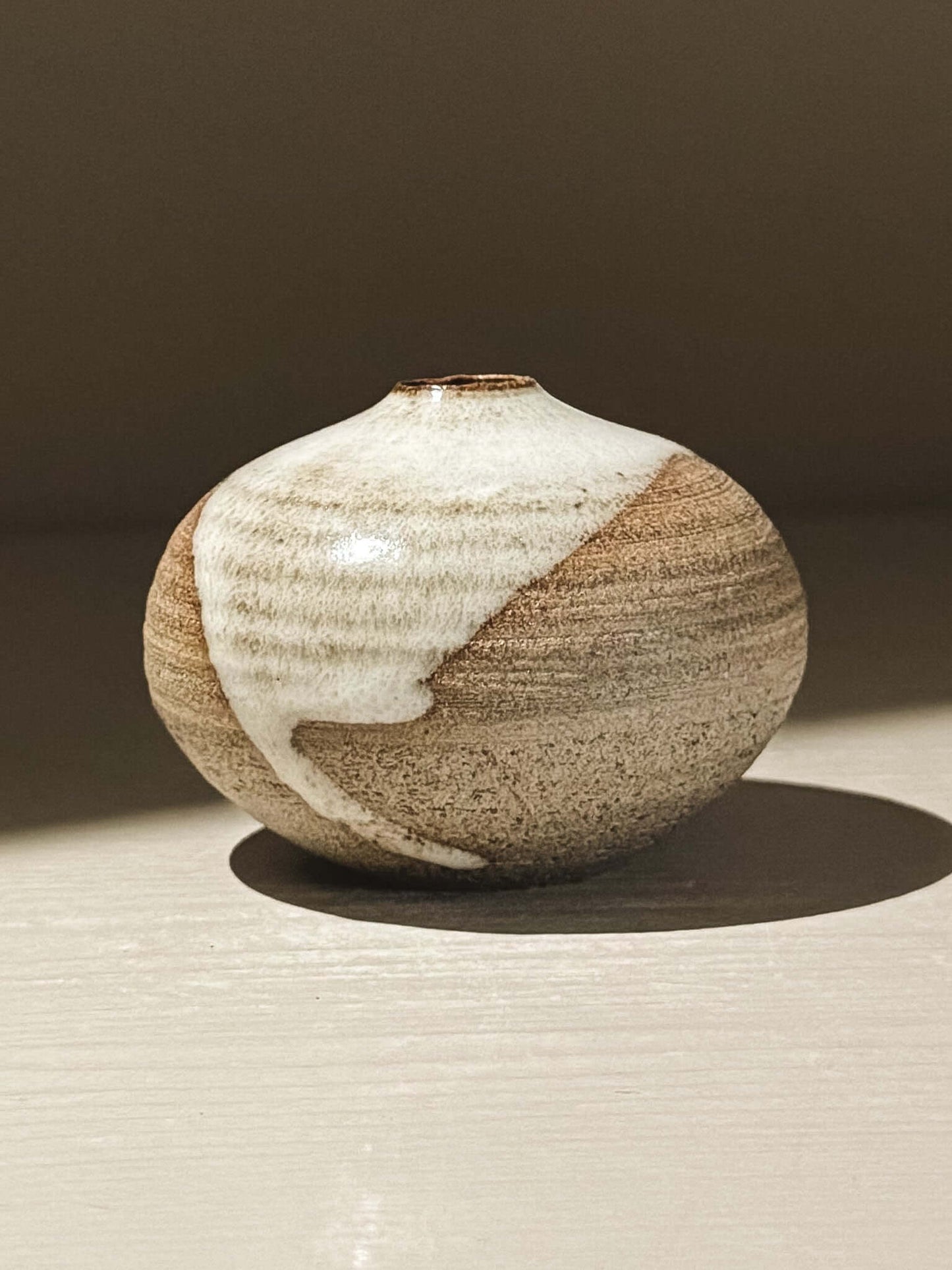 Handmade ceramic Japanese orb vase, Orb Vase – Yuki Ash #16 with unique glaze patterns.