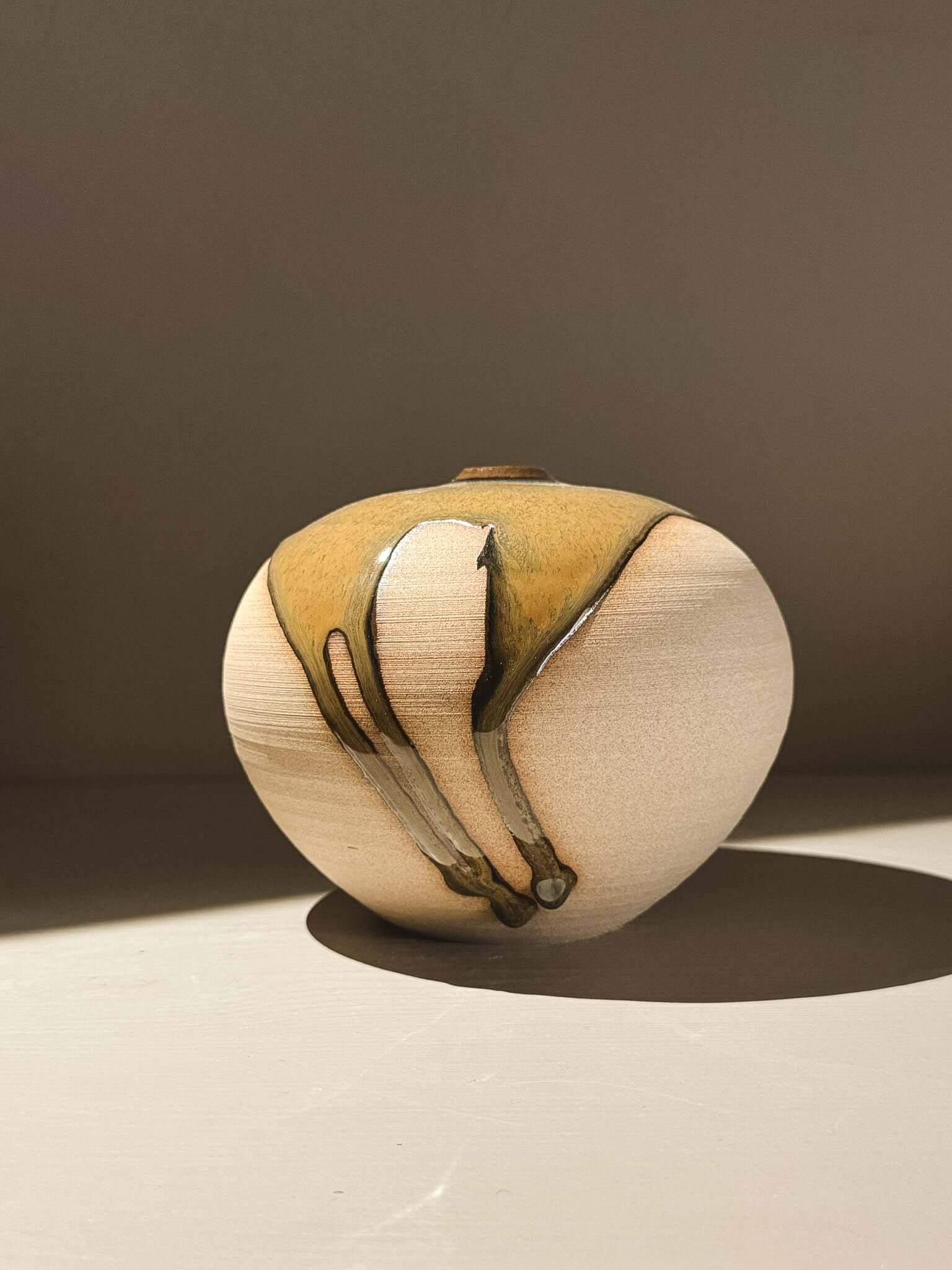 Handmade ceramic Japanese orb vase – Tenmoku #03 with unique glaze patterns and soft spherical form.