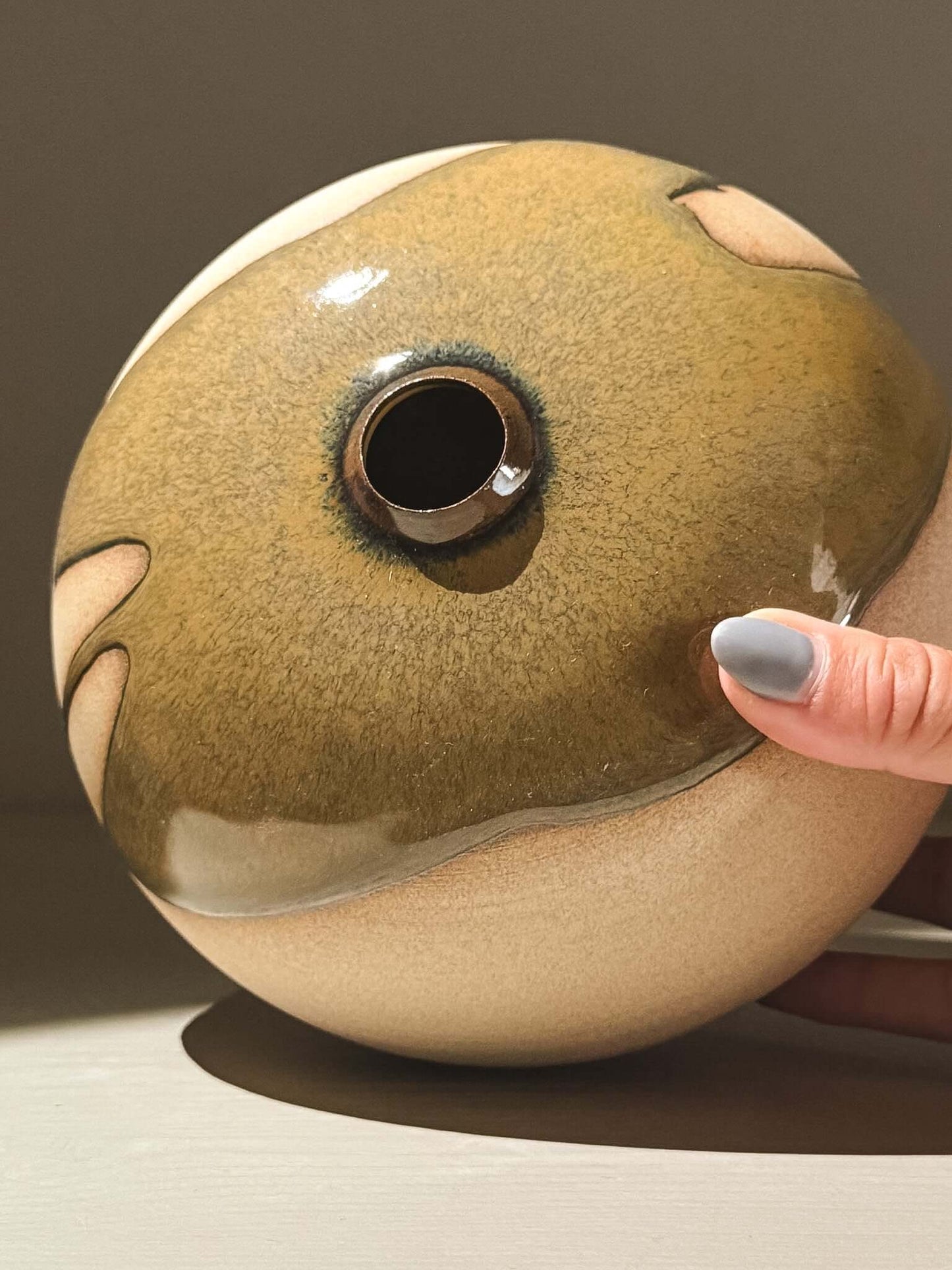 Handmade ceramic Japanese orb vase – Tenmoku #03 showcasing unique glaze and rounded shape.