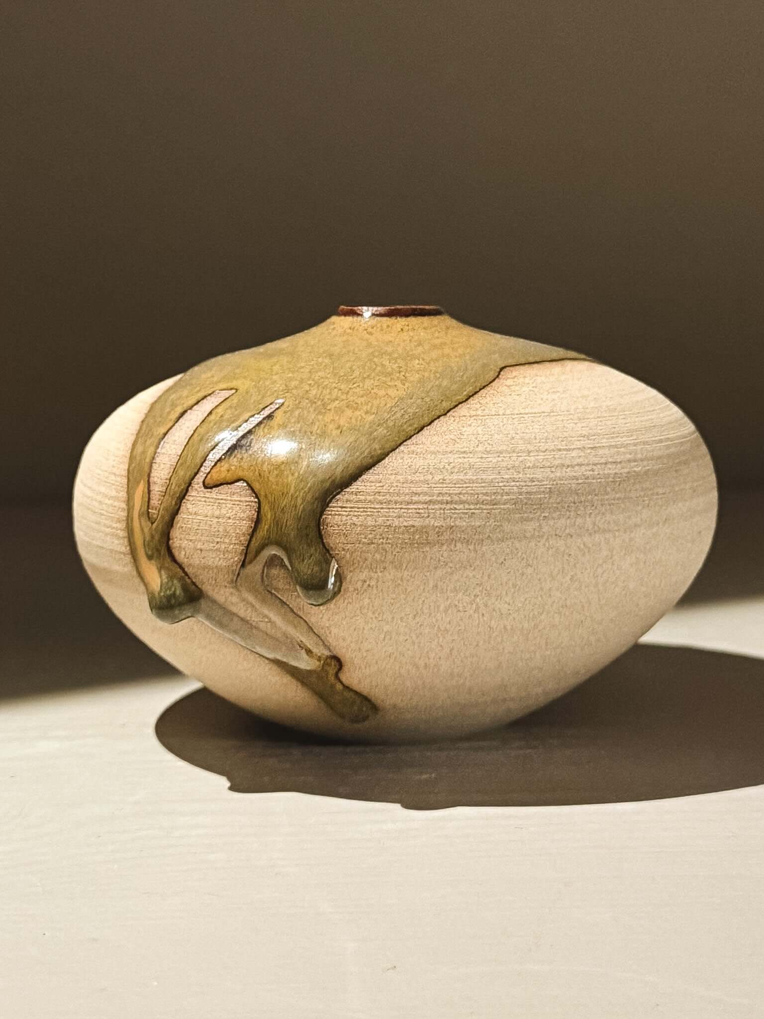 Handmade ceramic Japanese orb vase, Orb Vase – Tenmoku #04 with unique glaze movement and soft spherical form.