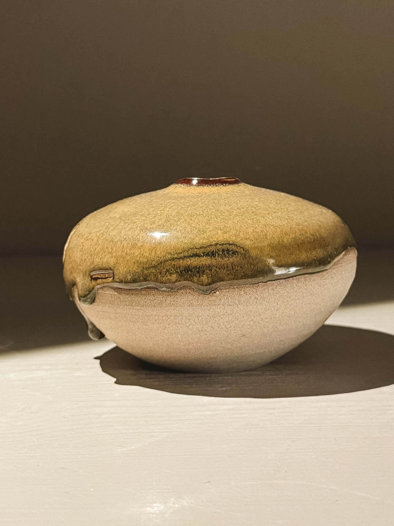 Handmade ceramic Japanese orb vase, part of the Orb Vase – Tenmoku #06 collection with unique glaze patterns.