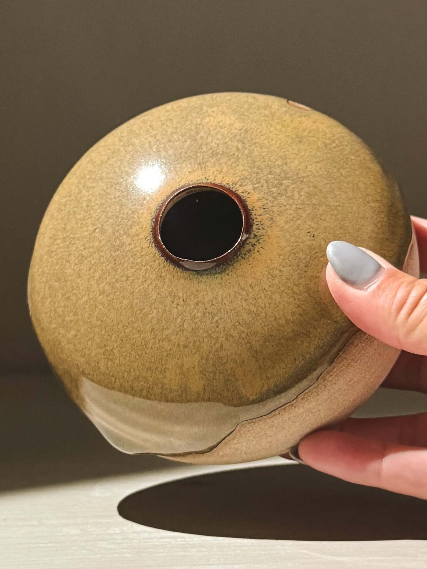 Handmade ceramic Japanese orb vase, Orb Vase – Tenmoku #06, showcasing unique glaze and organic patterns.