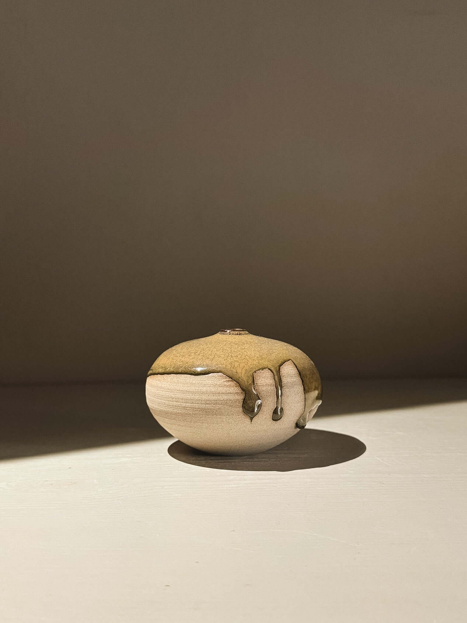 Orb Vase – Tenmoku #07 showcasing a unique glaze pattern on a rounded, sculptural form.