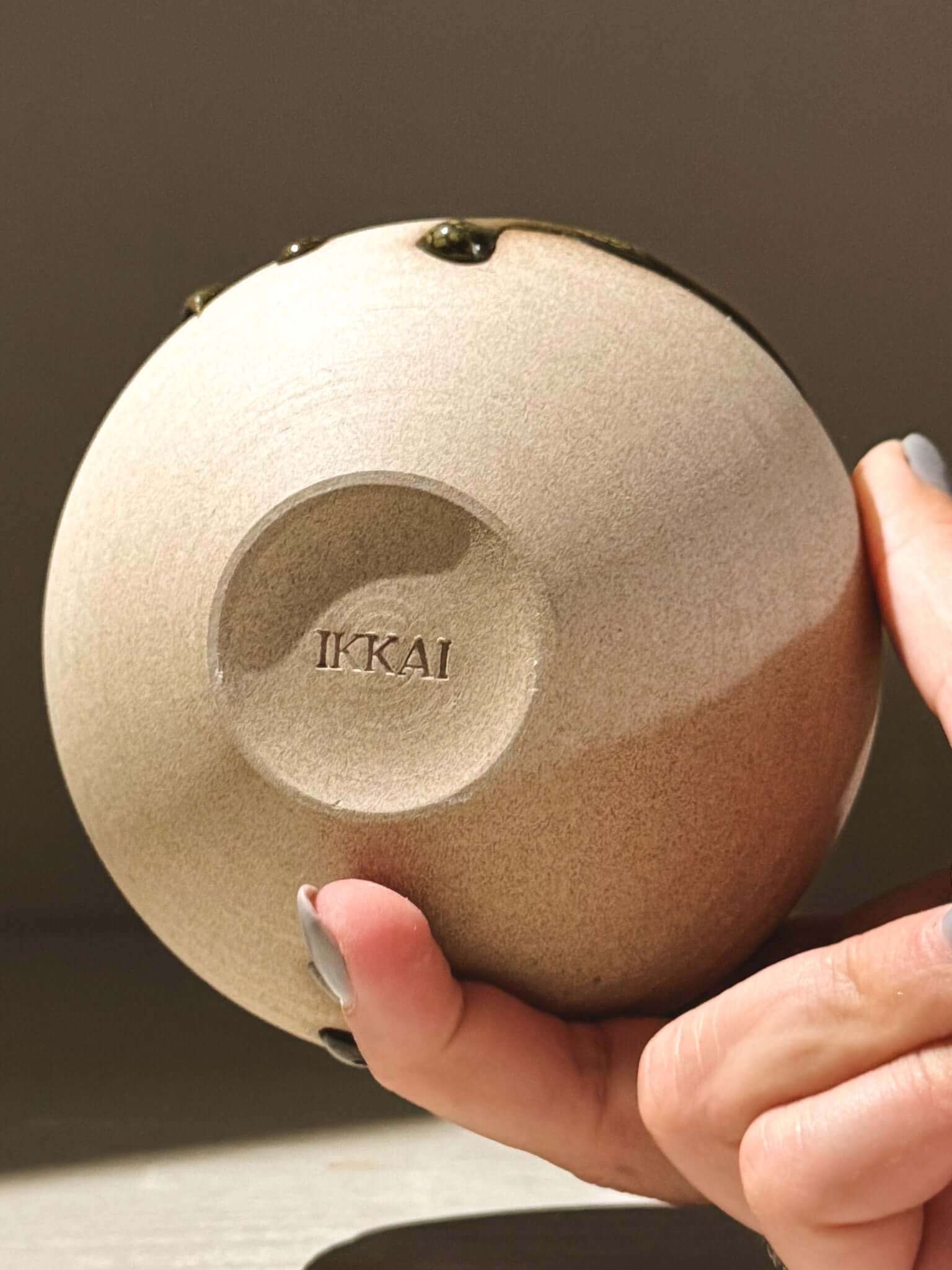 Orb Vase – Tenmoku #07 held in hand showcasing unique glaze and texture detail.