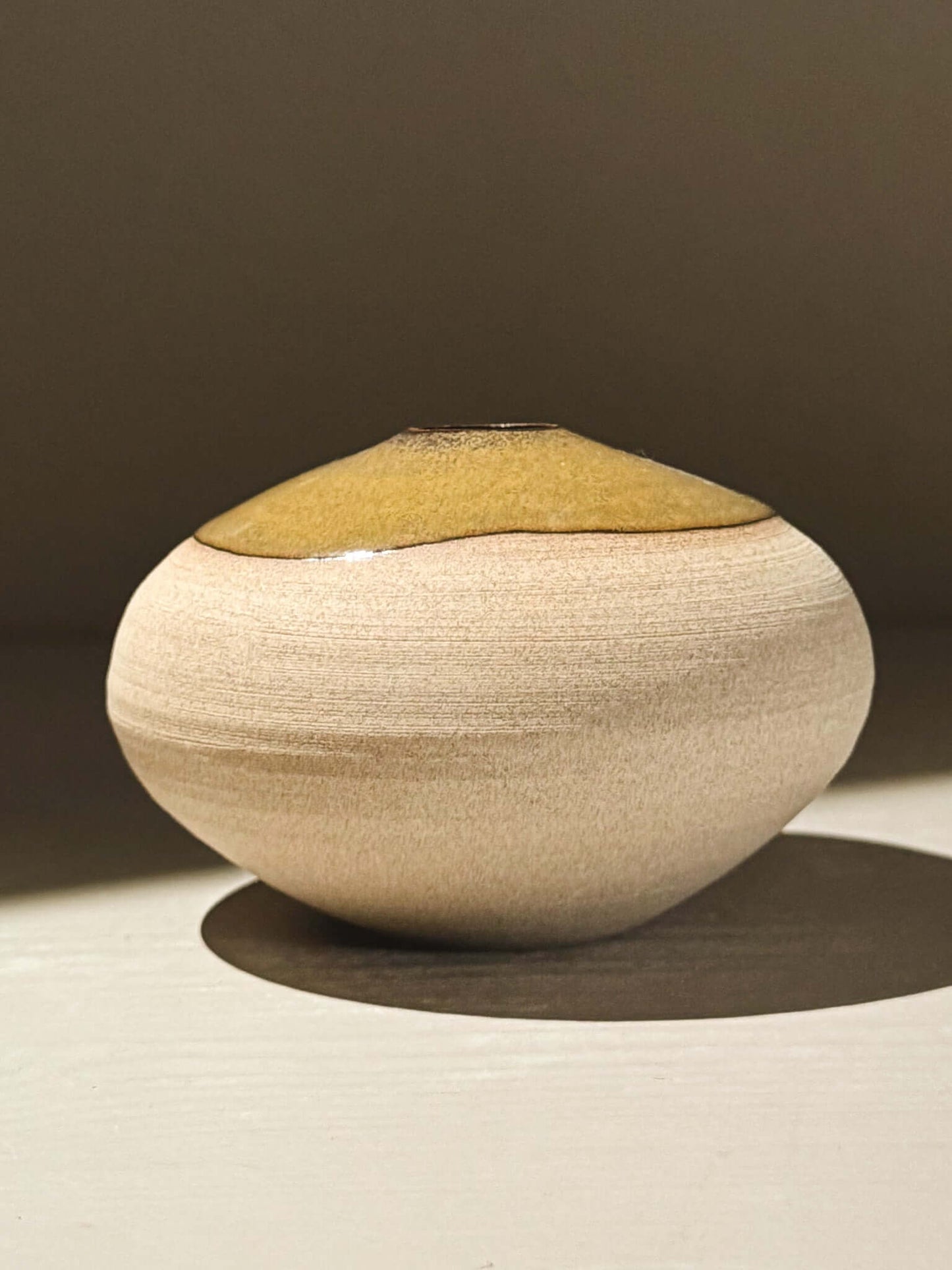Orb Vase – Tenmoku #08, handmade ceramics with a smooth beige surface and unique glaze pattern.