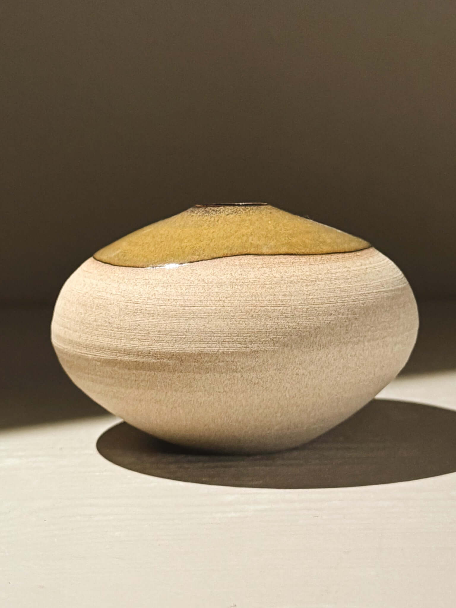 Orb Vase – Tenmoku #08, handmade ceramics with a smooth beige surface and unique glaze pattern.