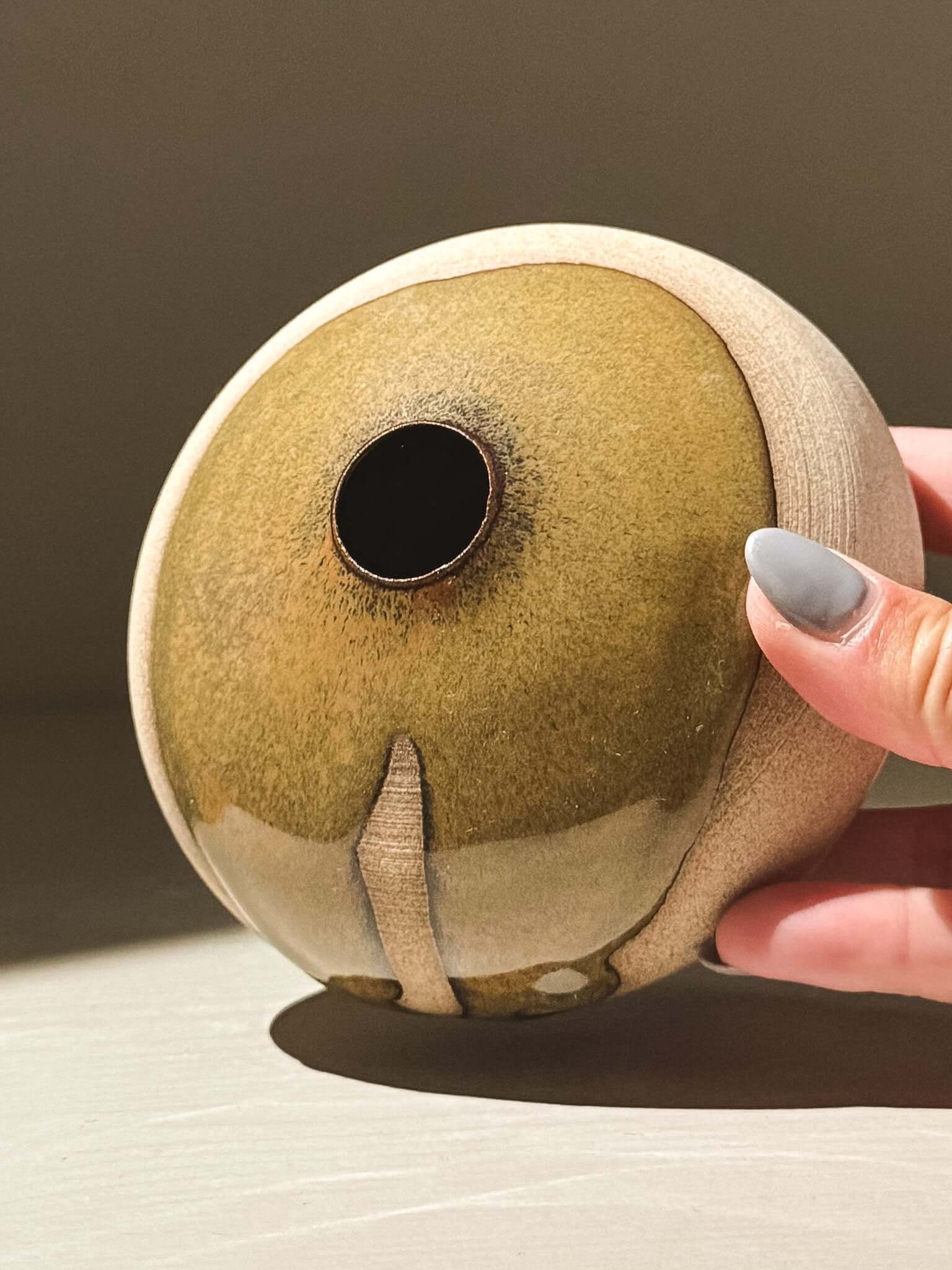 Handmade ceramics Orb Vase – Tenmoku #08 with organic glaze patterns and soft spherical form.