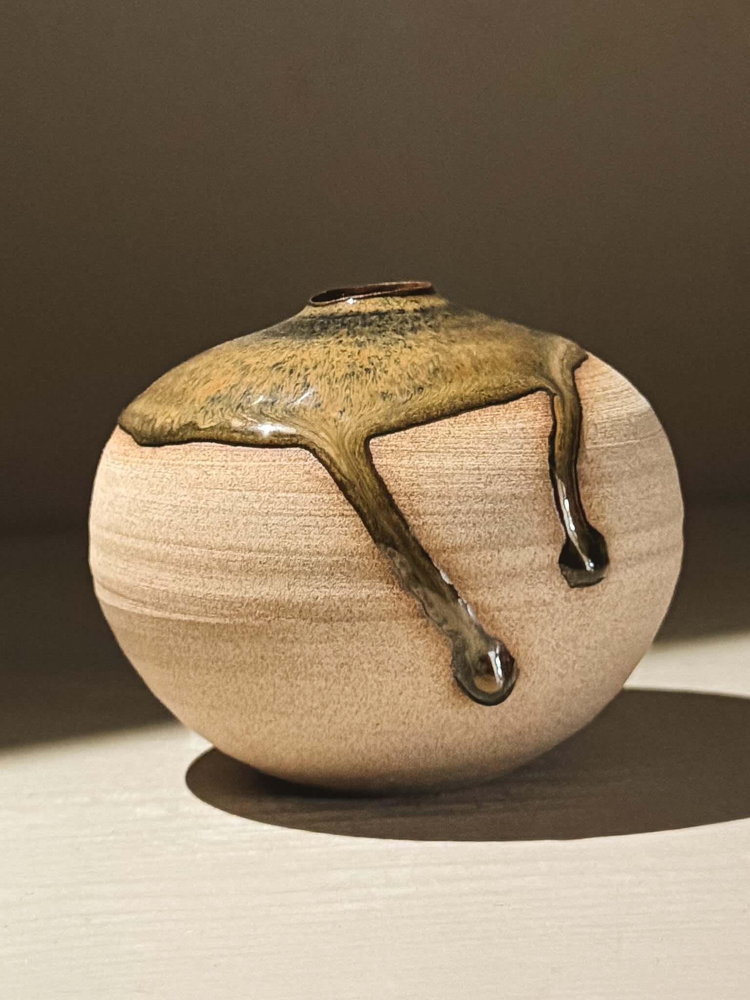 Orb Vase – Tenmoku #09, handmade ceramics with unique glaze movement and soft spherical form.