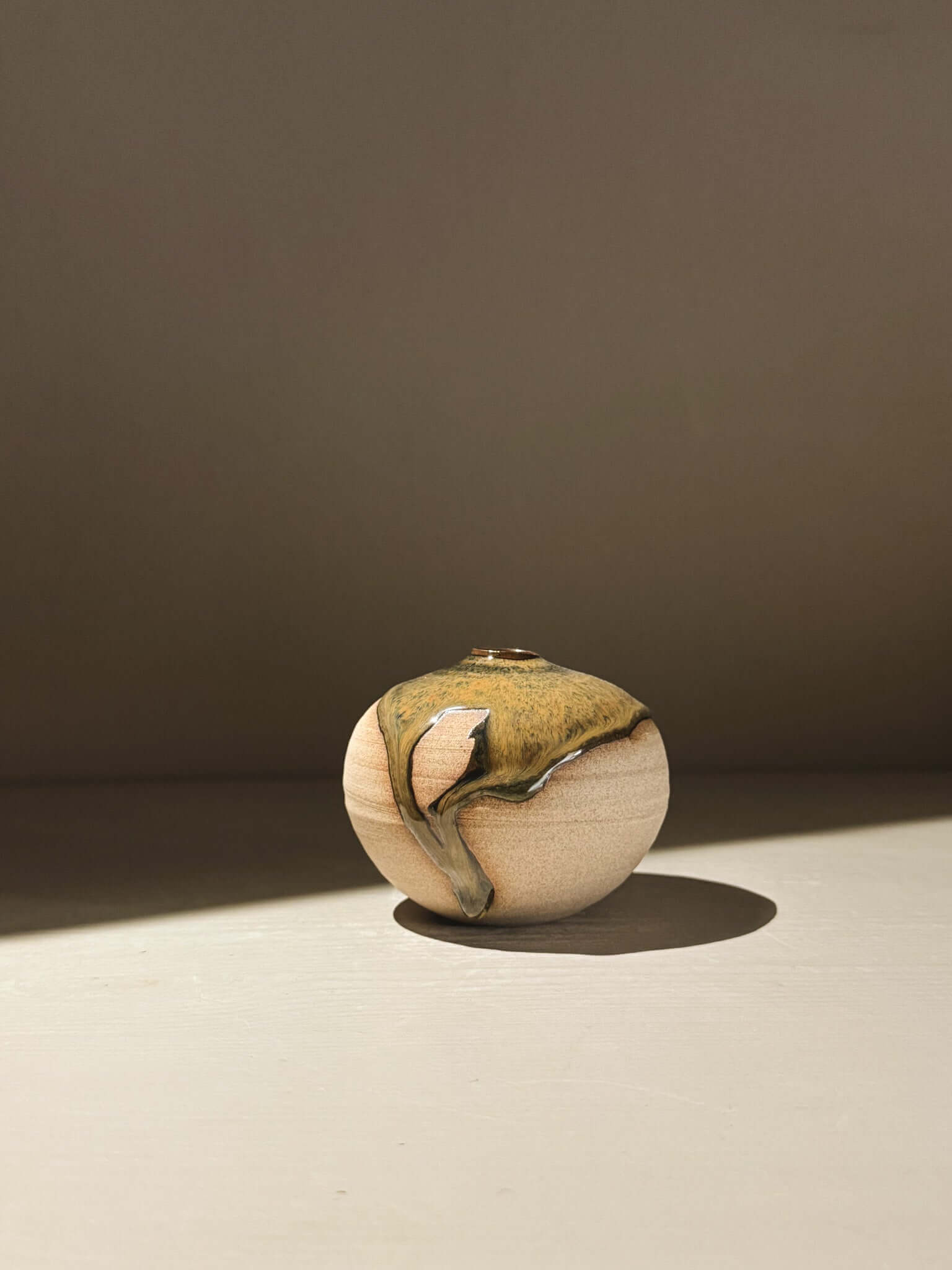 Orb Vase – Tenmoku #09, uniquely handmade ceramics with gentle glaze movement and organic patterns.