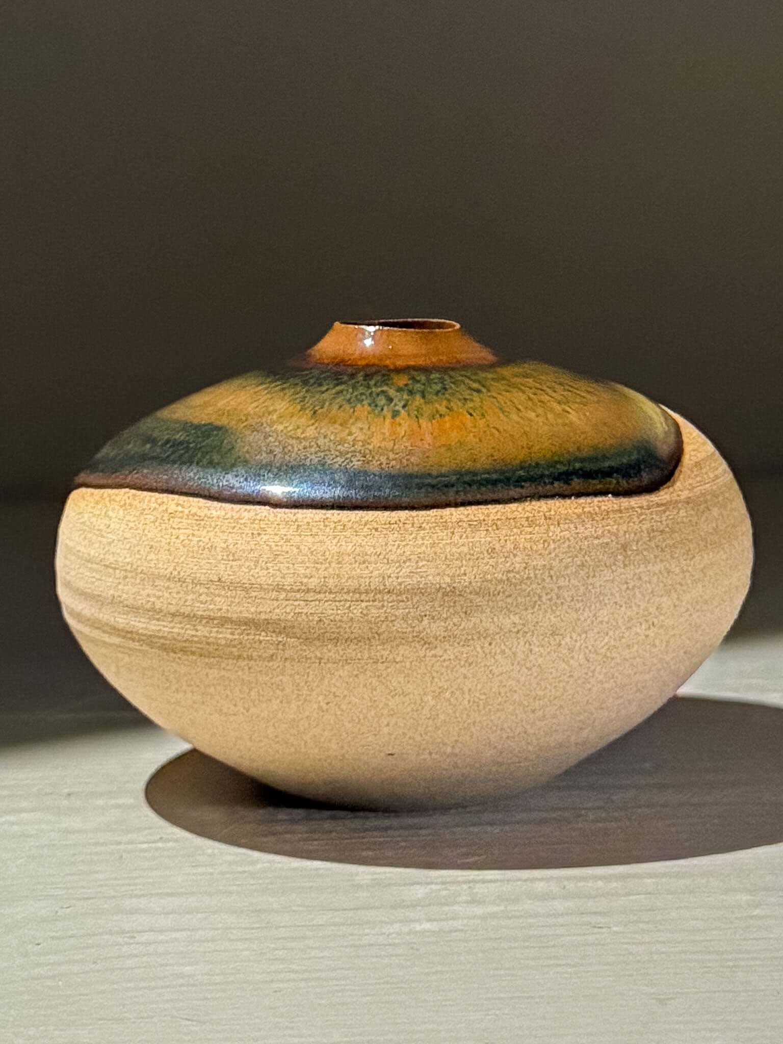 Orb Vase – Tenmoku #10, handmade ceramics with organic glaze and unique patterns.
