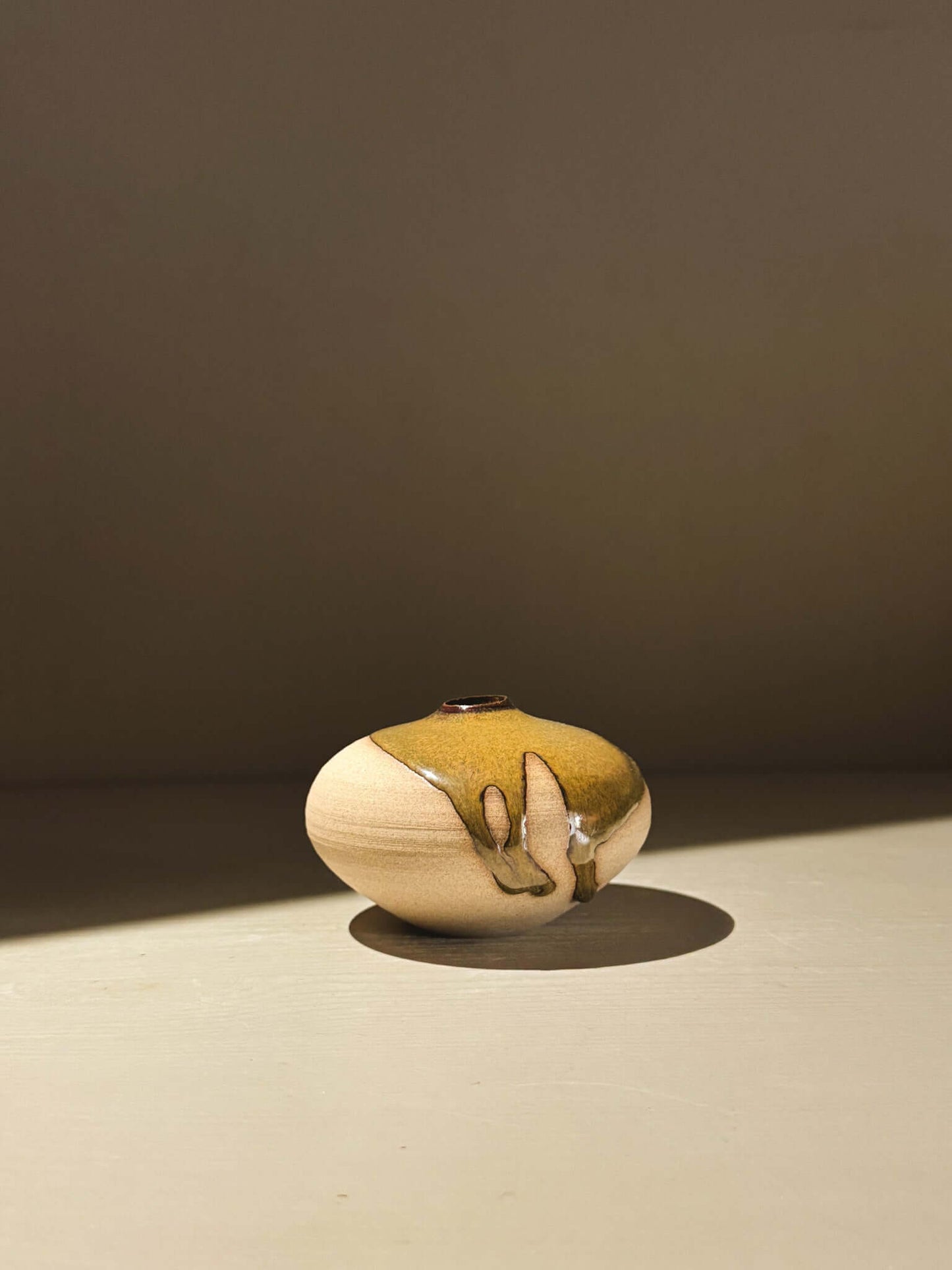 Handmade ceramics Orb Vase – Tenmoku #11 showcasing unique glaze patterns and soft, spherical form.