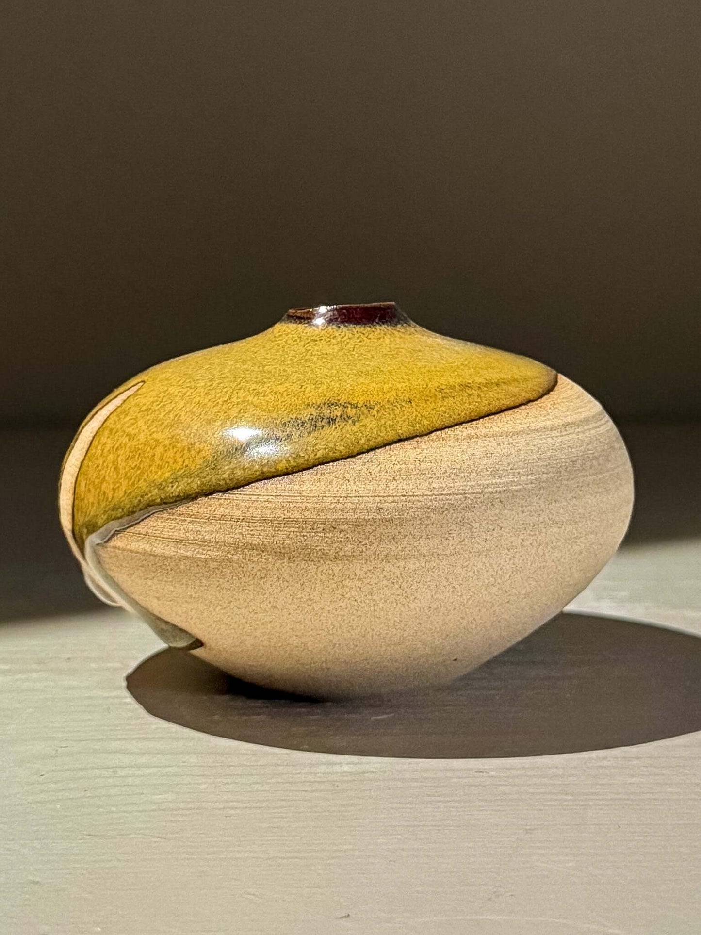 Orb Vase – Tenmoku #11, handmade ceramics with a unique glaze and rounded sculptural form.