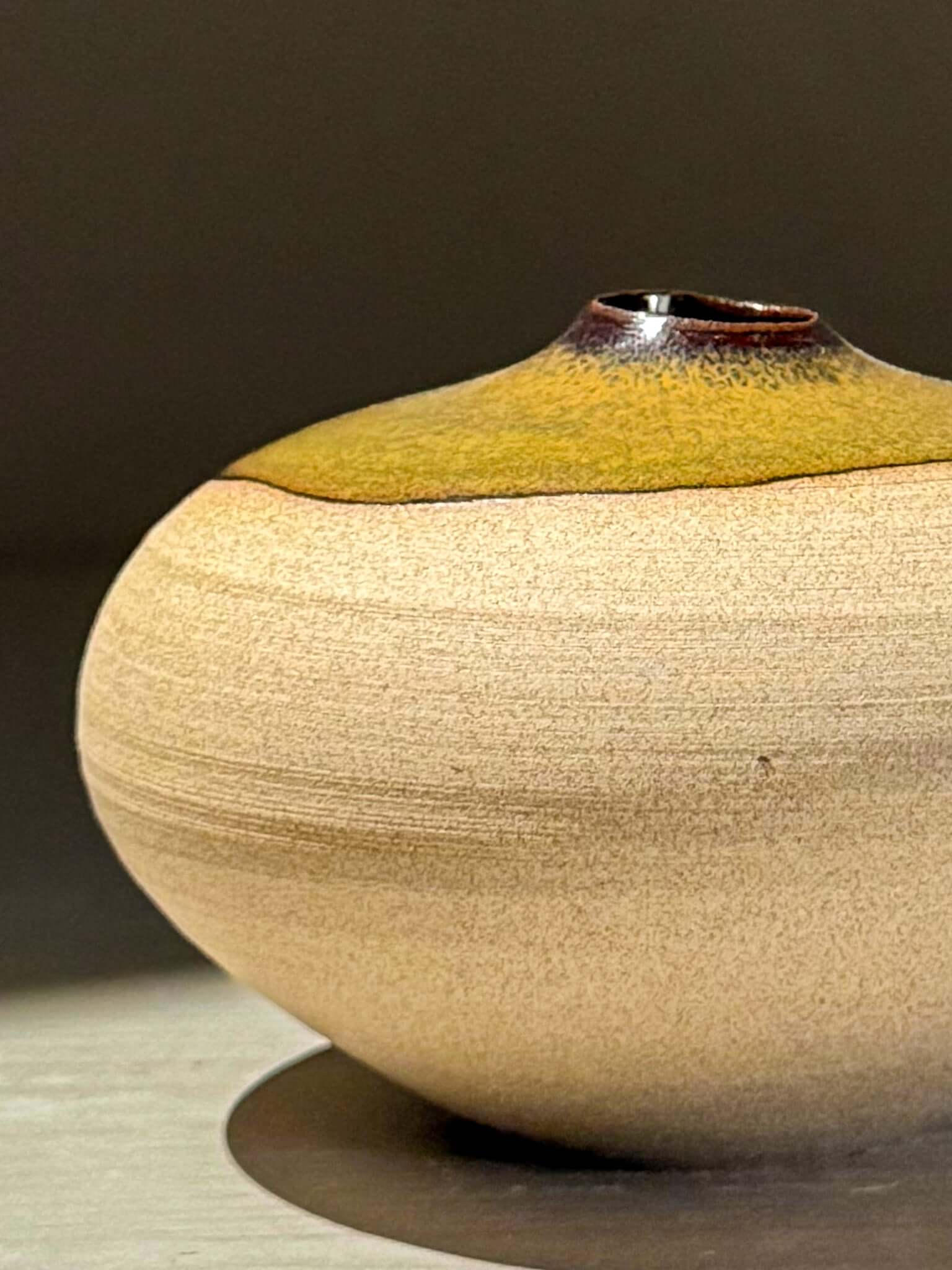 Orb Vase – Tenmoku #11 showcasing handmade ceramics with unique glaze patterns and a sculptural round shape.