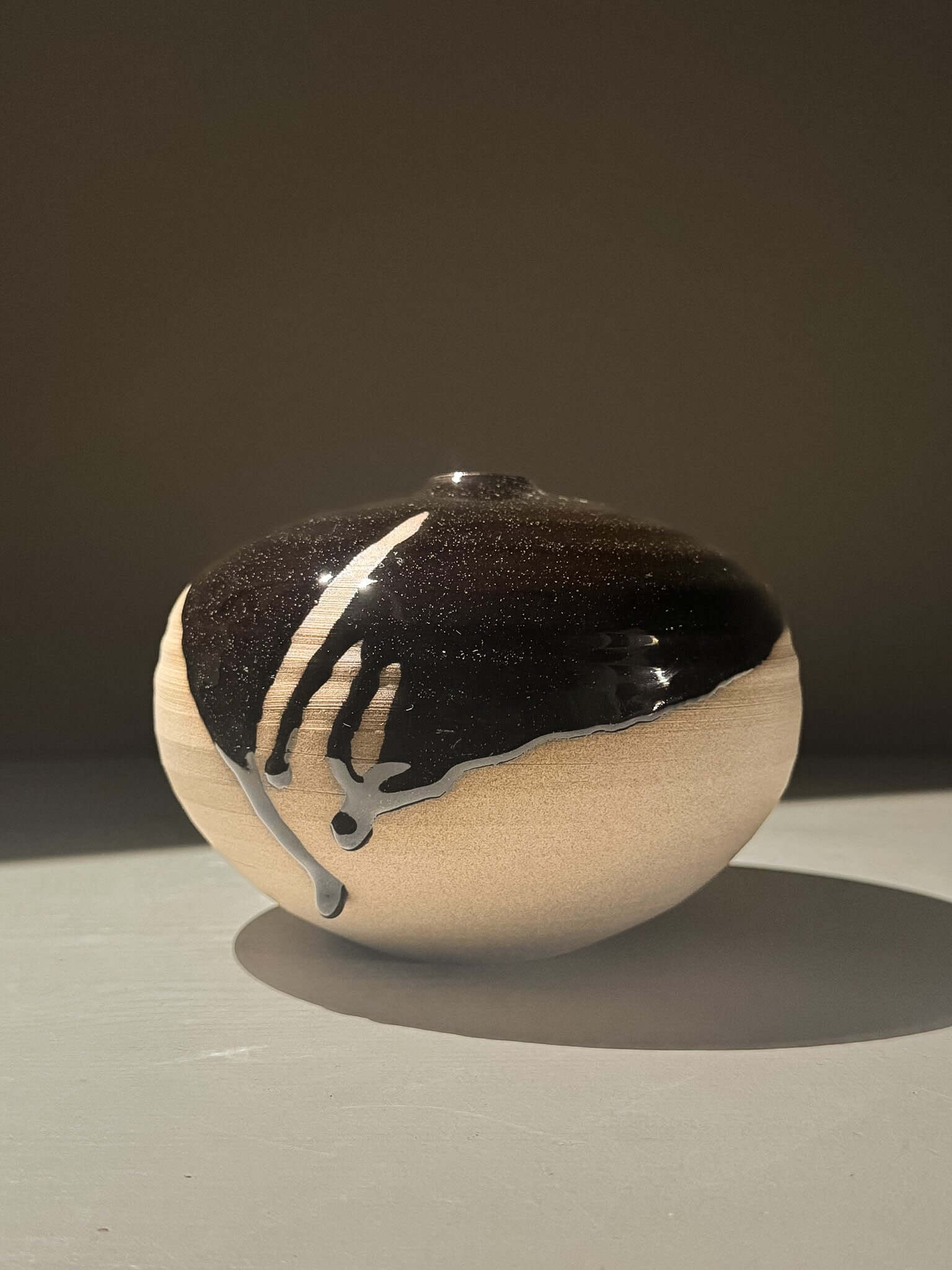Orb Vase – Kuro #0 showcasing a unique glaze pattern and soft spherical form for a sculptural presence.