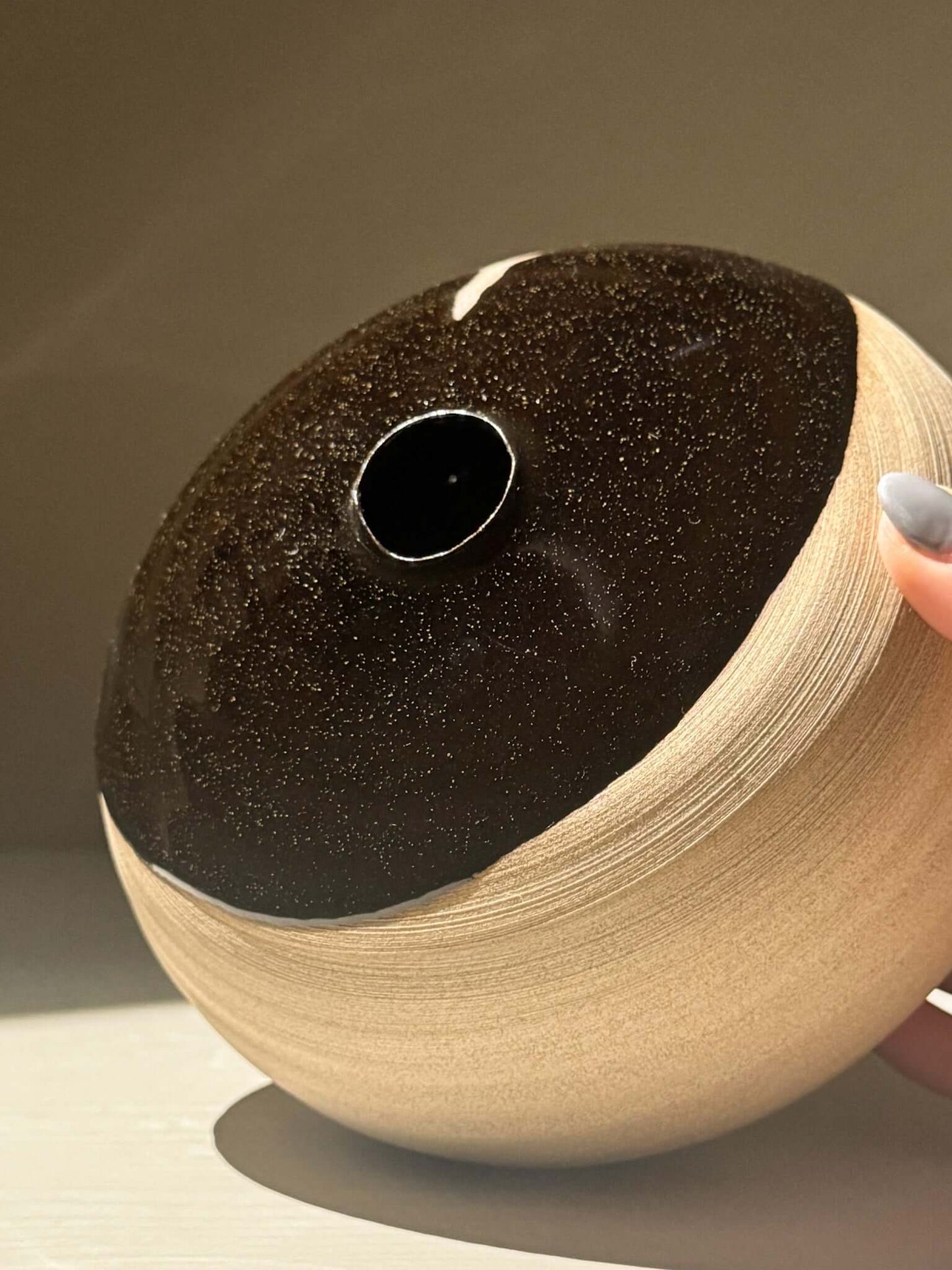 Orb Vase – Kuro #0 showing its unique glaze and rounded shape, highlighting its sculptural presence and craftsmanship.