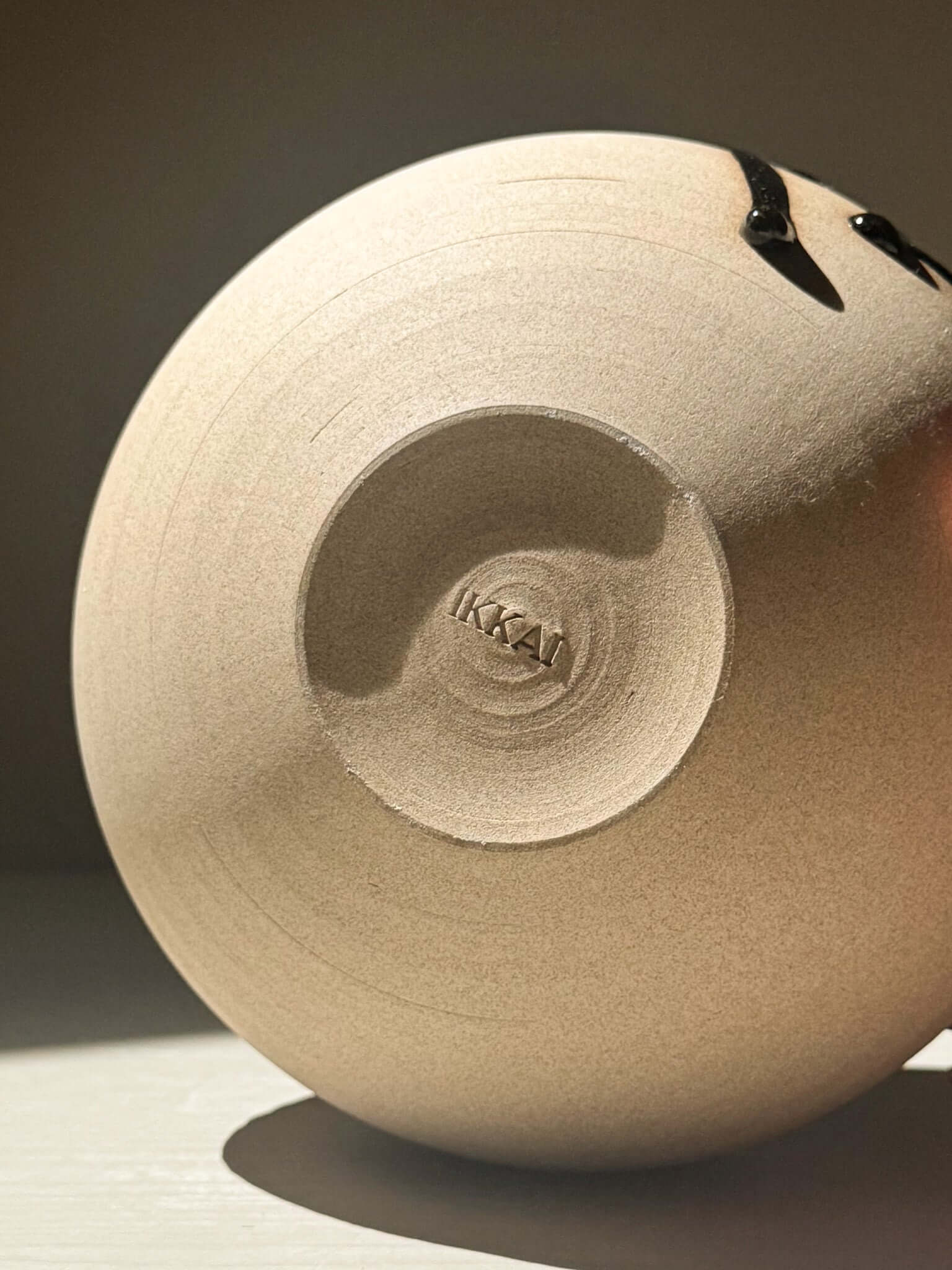 Orb Vase – Kuro #0, showing unique glaze movement and rounded shape detail.