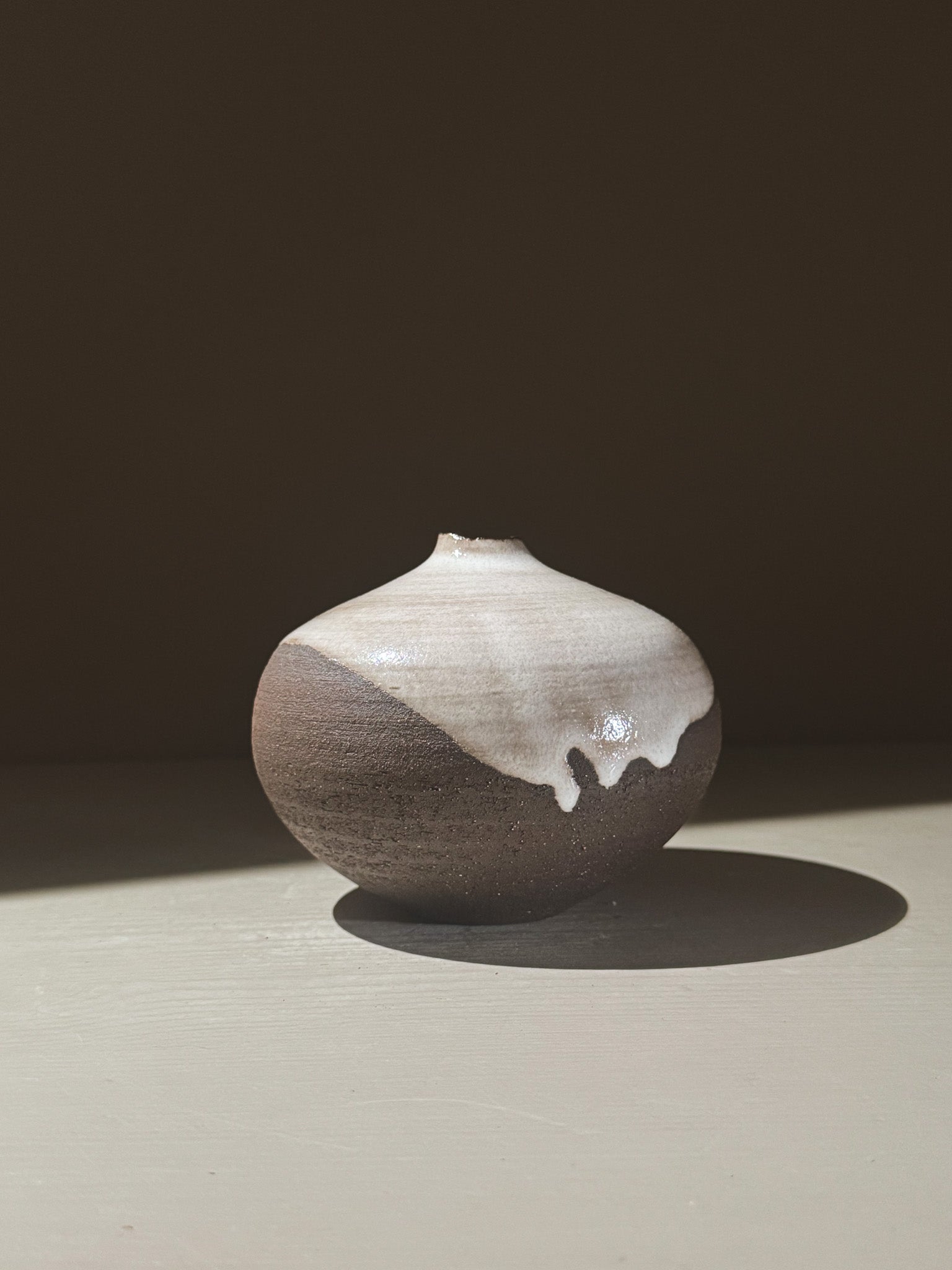 Orb Vase – Yuki Black #03, a unique spherical vase with gentle glaze drips and organic patterns.