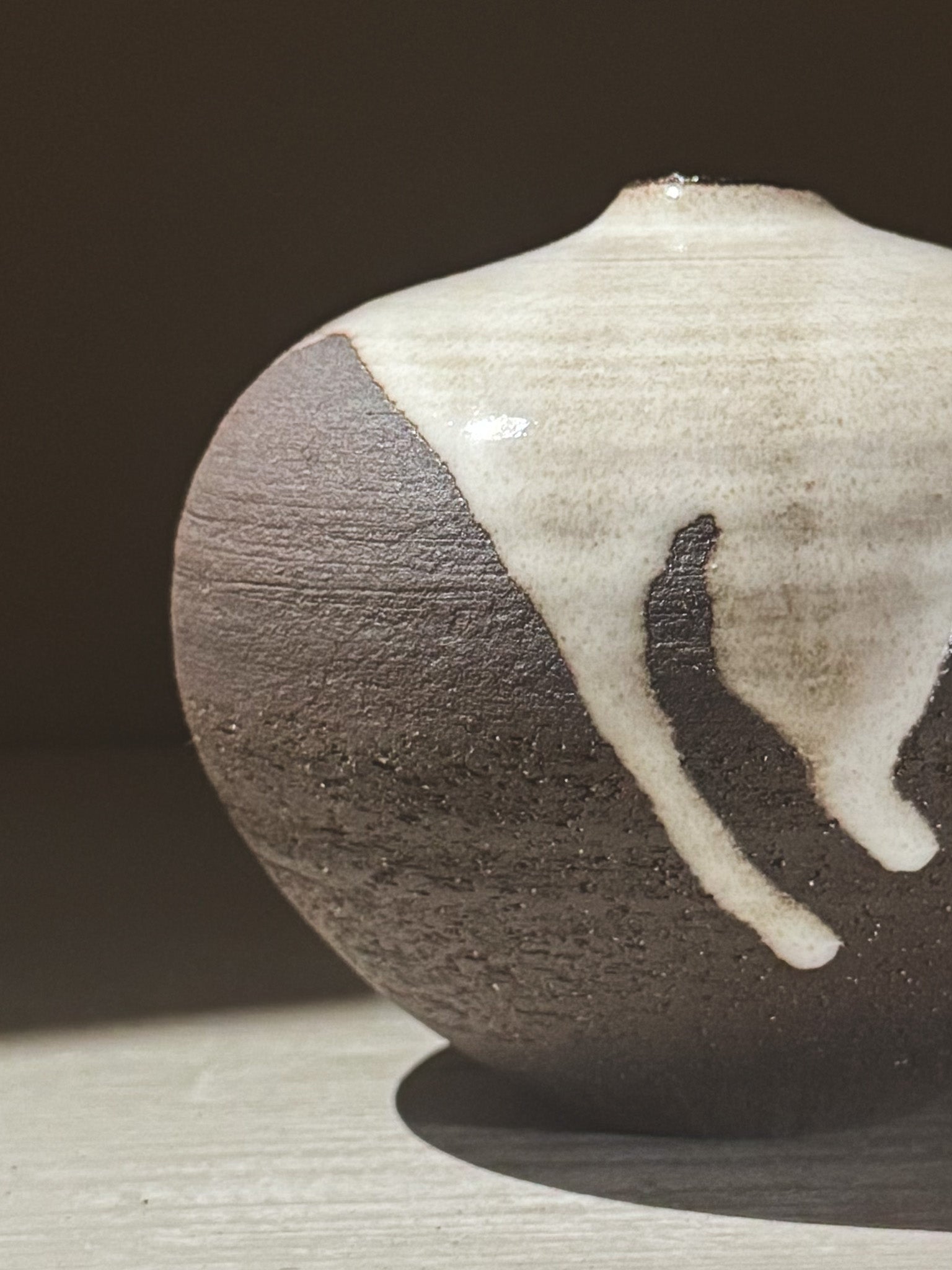 Orb Vase – Yuki Black #04 showcasing a unique glaze pattern and soft spherical shape.