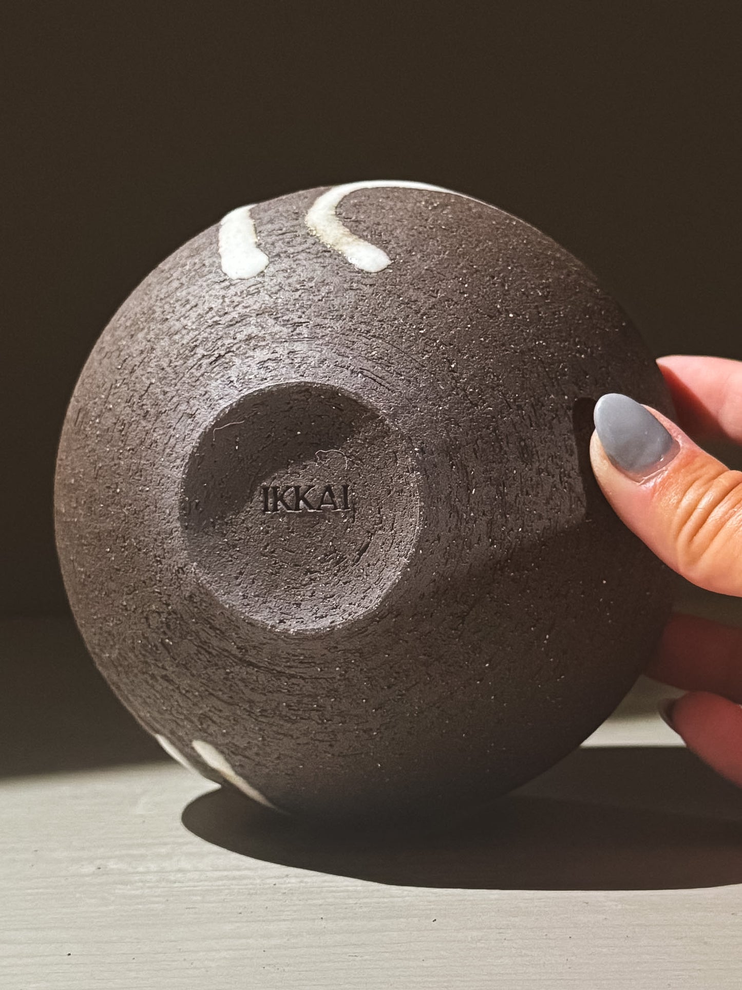Orb Vase – Yuki Black #04 featuring a unique textured surface and organic design, held in hand against a neutral background.
