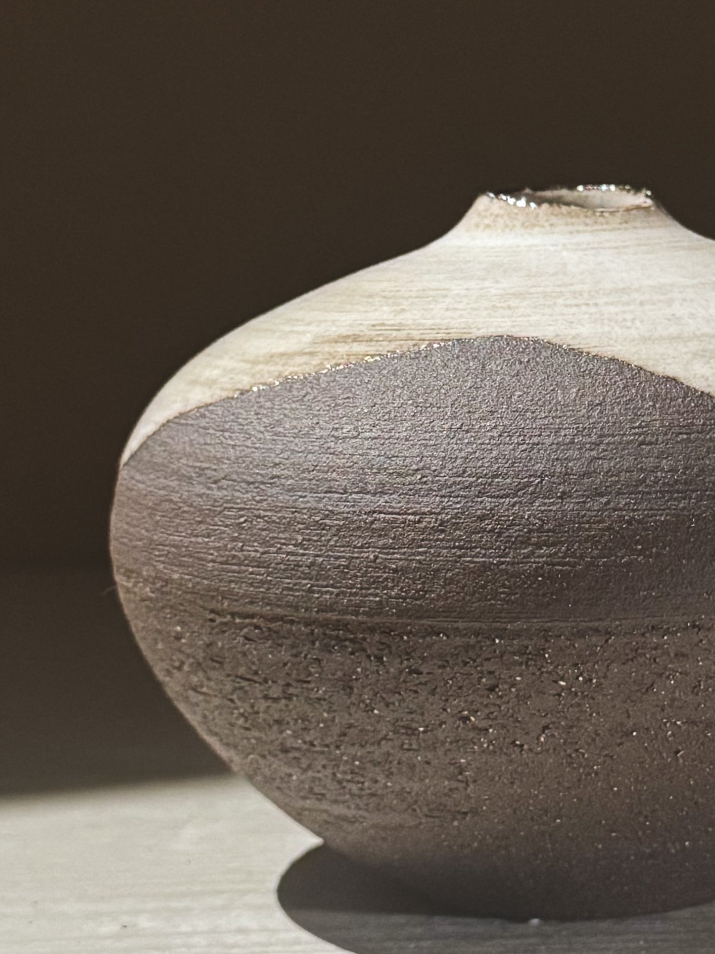 Orb Vase – Yuki Black #05 showcasing unique glaze movement and sculptural rounded form on a soft lit surface.