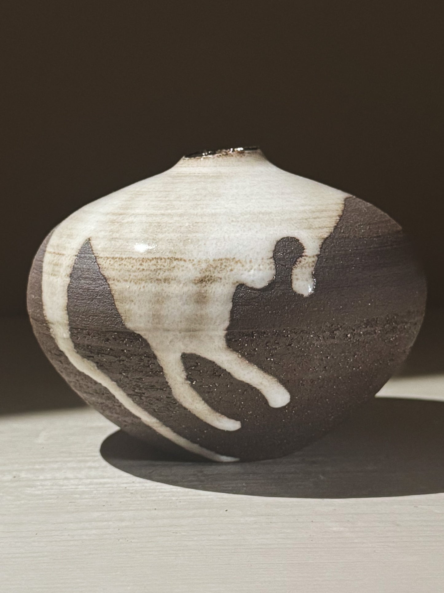 Orb Vase – Yuki Black #05 showcasing unique glaze movement and a soft spherical form.
