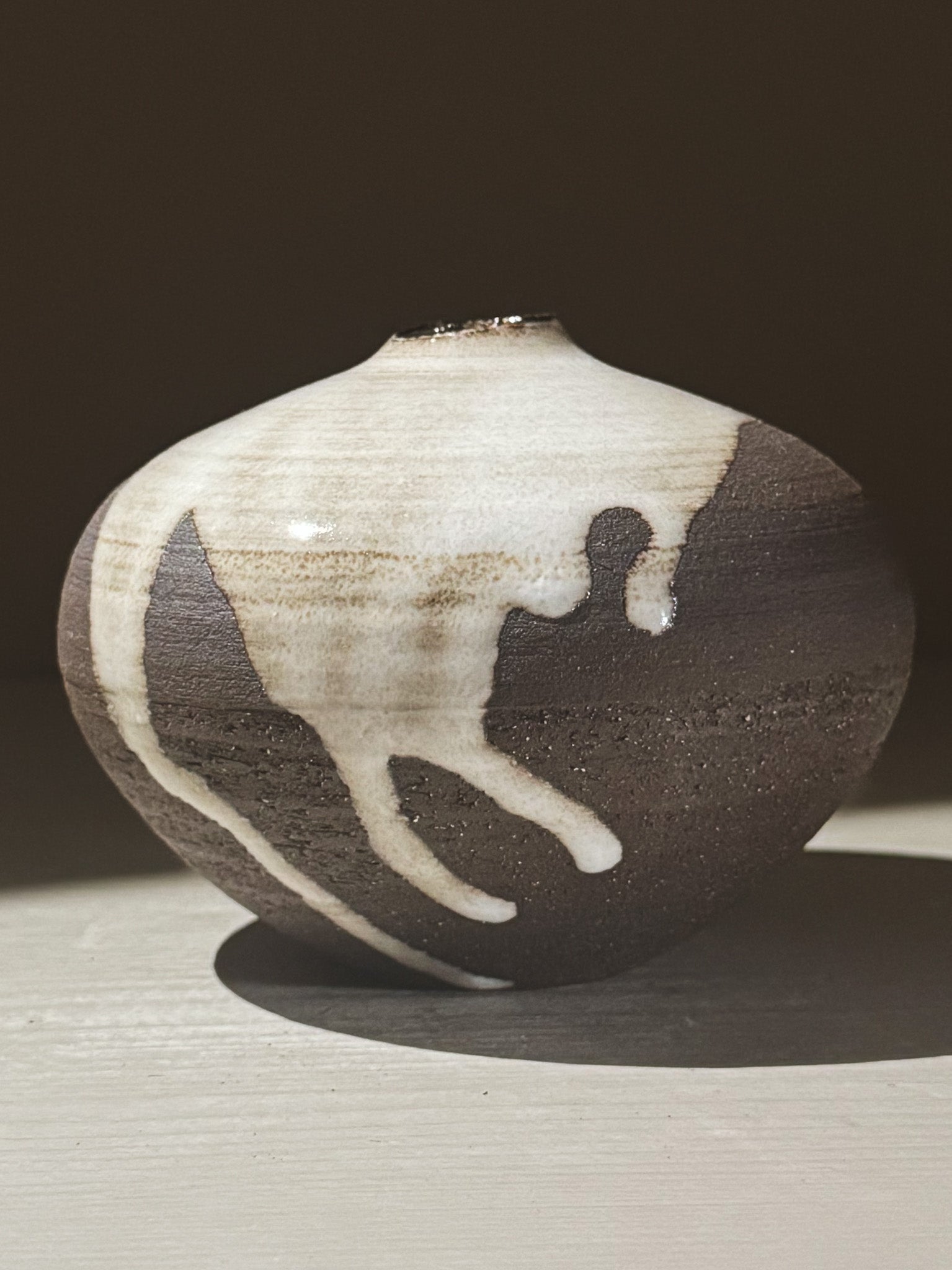Orb Vase – Yuki Black #05 showcasing unique glaze movement and a soft spherical form.