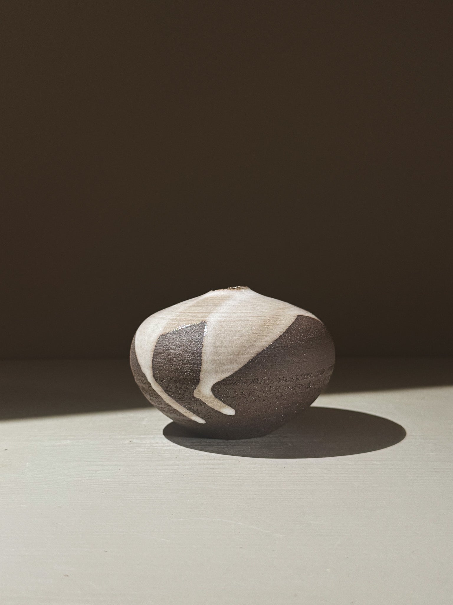 Orb Vase – Yuki Black #06 showcasing unique glaze patterns and soft spherical design.