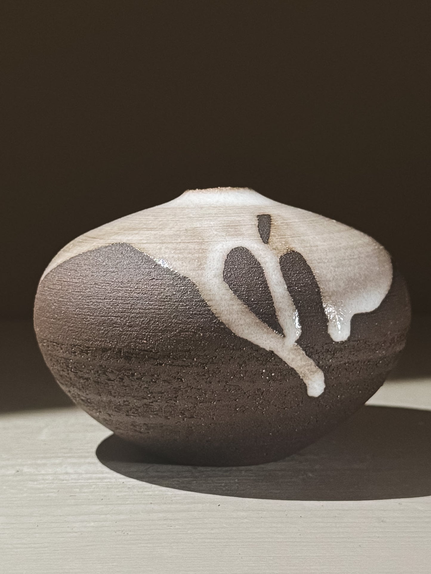 Orb Vase – Yuki Black #06 showcasing unique glaze patterns and rounded shape.