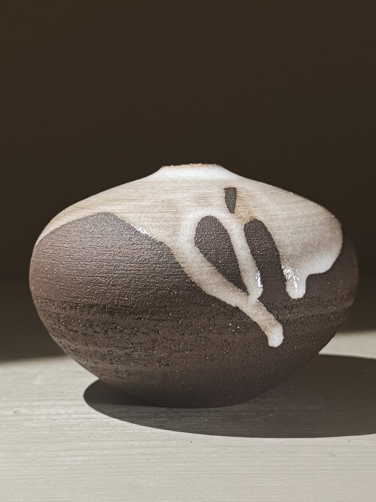 Orb Vase – Yuki Black #06 showcasing unique glaze patterns and rounded shape.