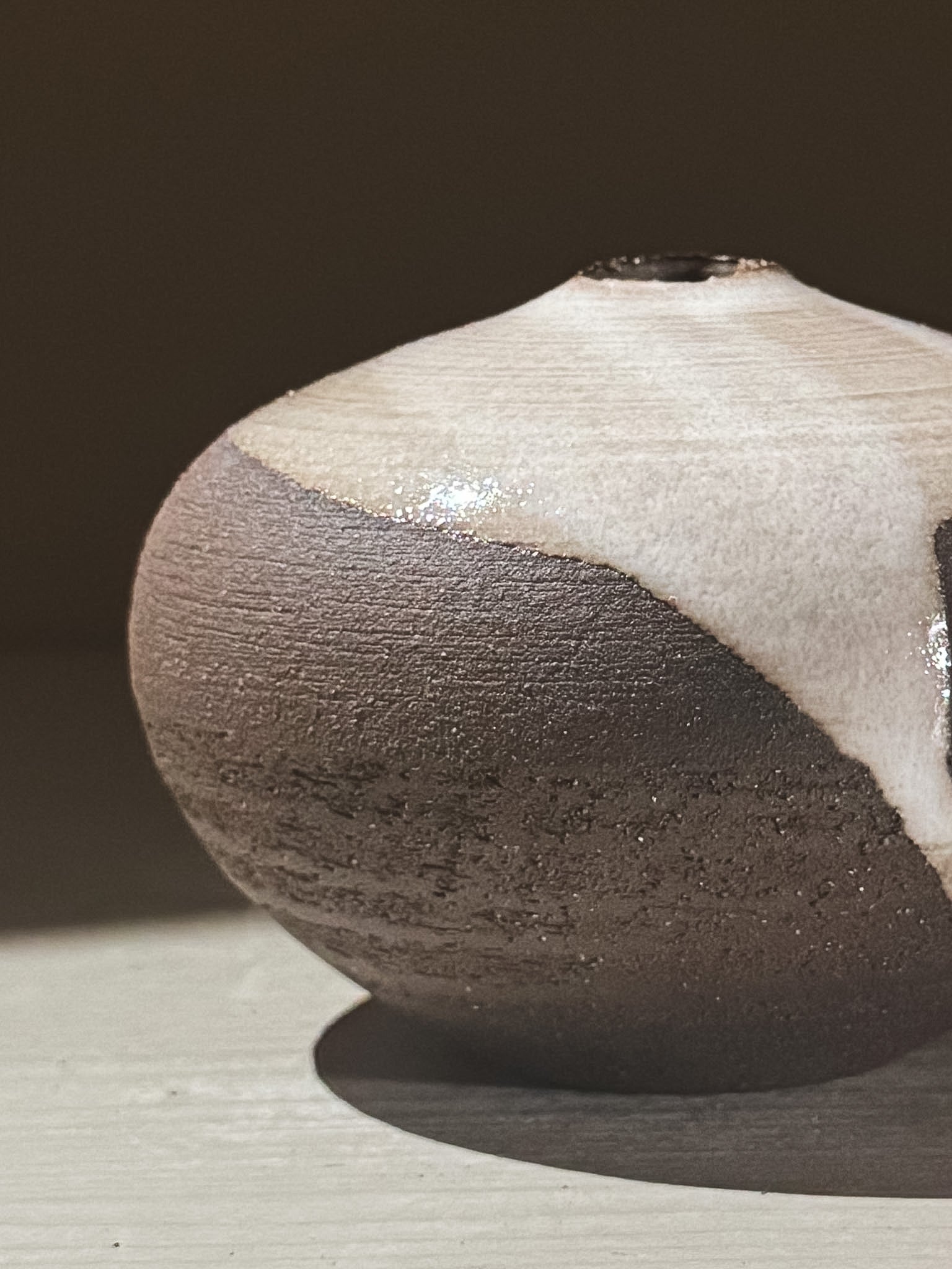 Orb Vase – Yuki Black #06 with unique glaze patterns and soft rounded shape, showcasing organic textures.