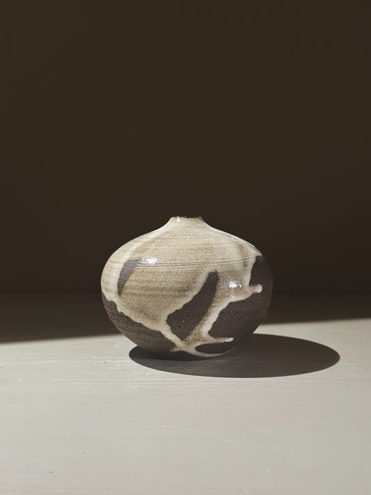 Orb Vase – Yuki Black #07 with unique glaze patterns and soft spherical form on a neutral background.