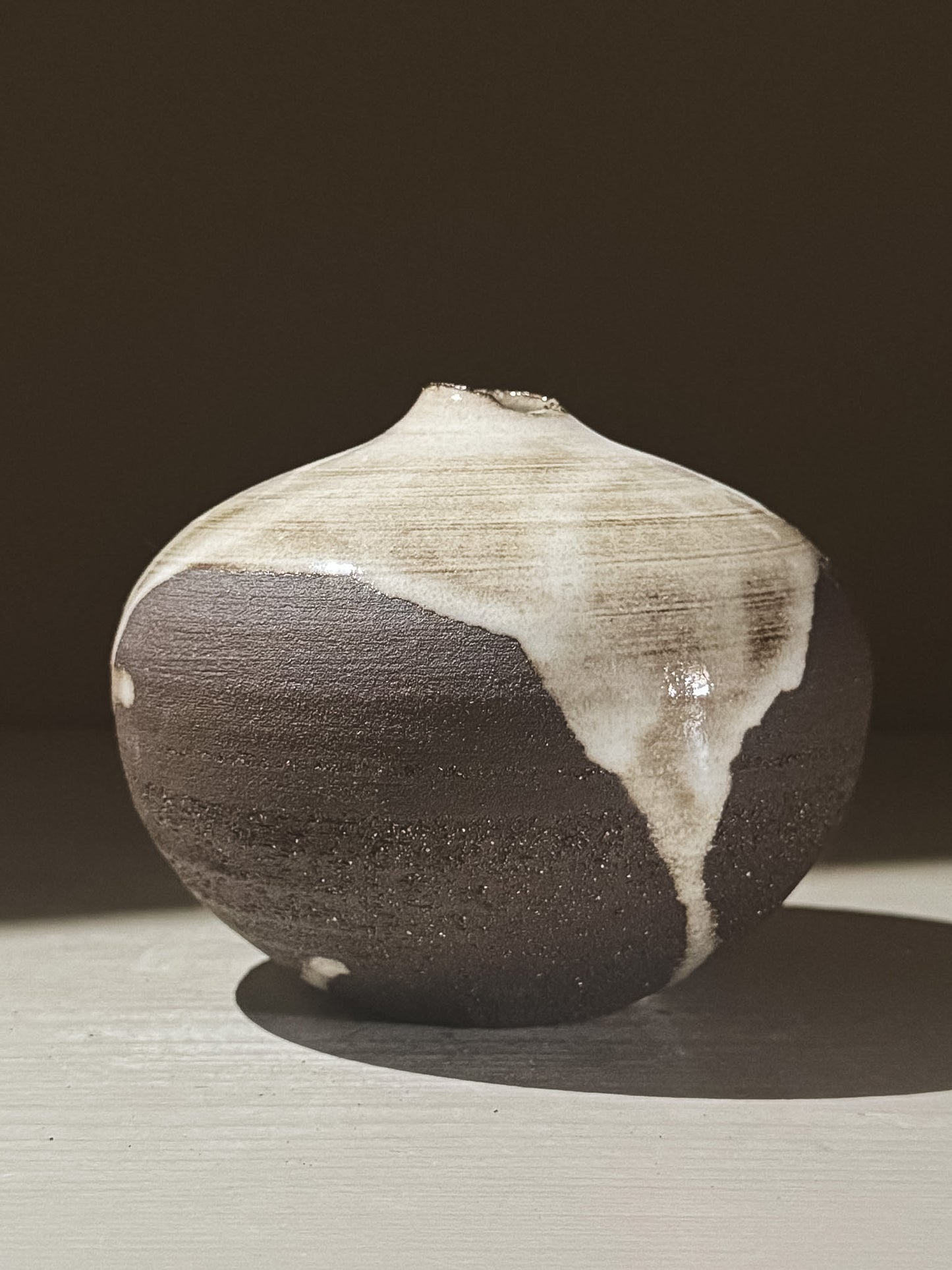 Orb Vase – Yuki Black #07 with unique glaze pattern and soft spherical shape, showcasing organic artistic design.