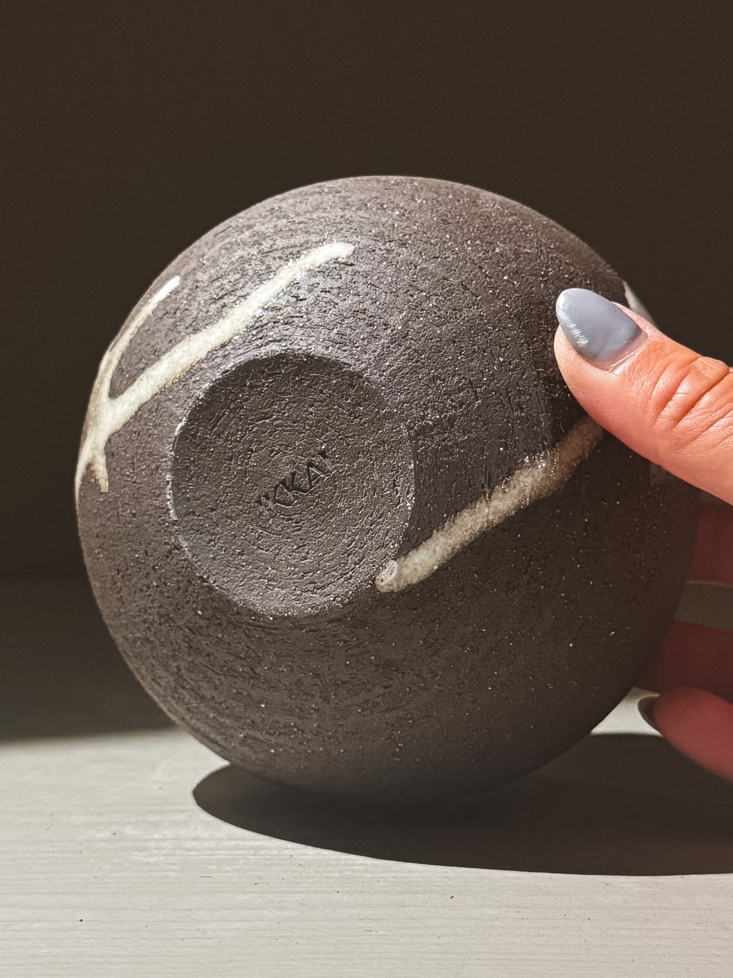 Orb Vase – Yuki Black #07 showcasing unique glaze and texture in a rounded black ceramic design.