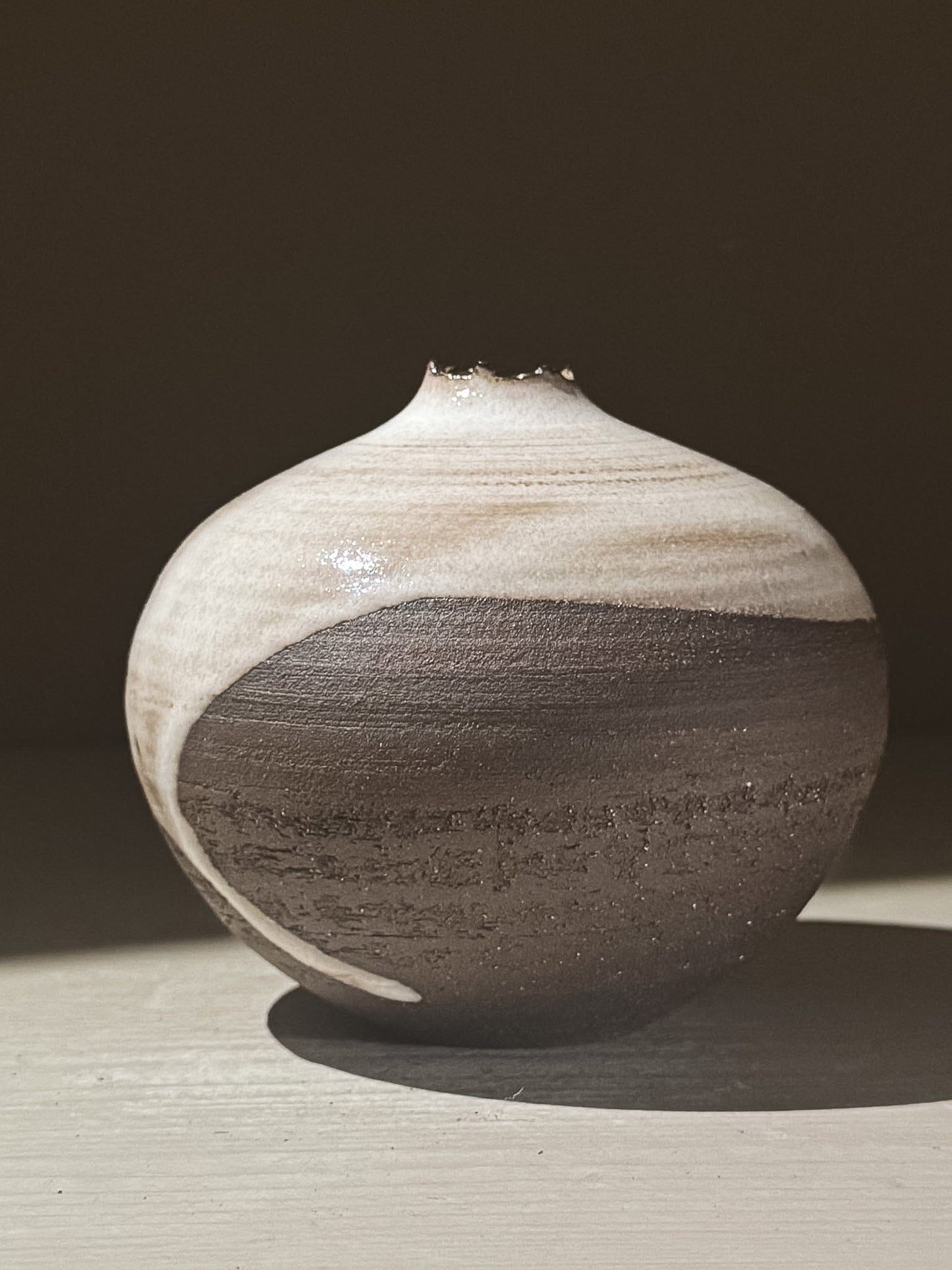Orb Vase – Yuki Black #08 with unique glaze patterns and soft spherical form, showcasing its artistic craftsmanship.