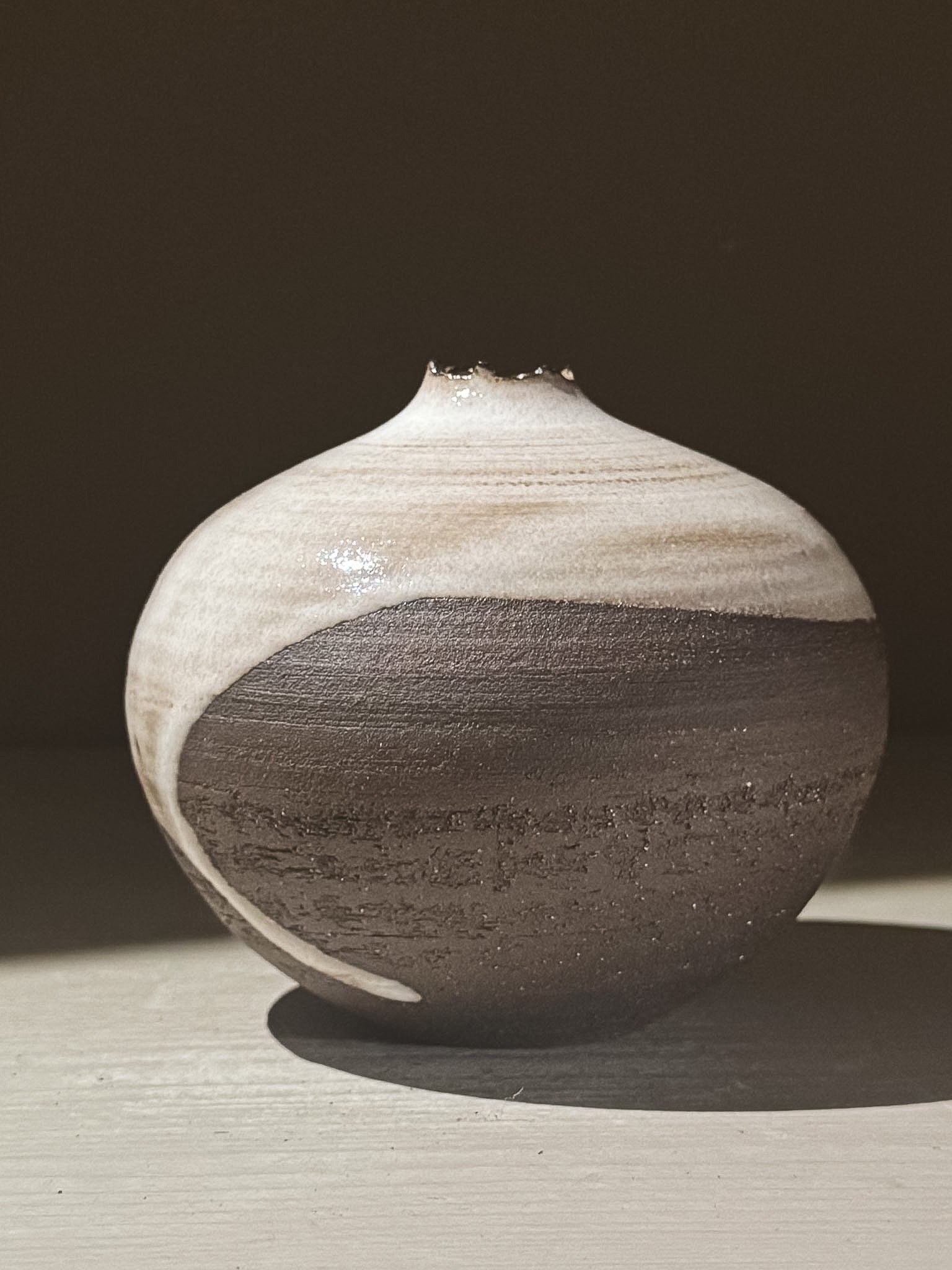 Orb Vase – Yuki Black #08 with unique glaze patterns and soft spherical form, showcasing its artistic craftsmanship.