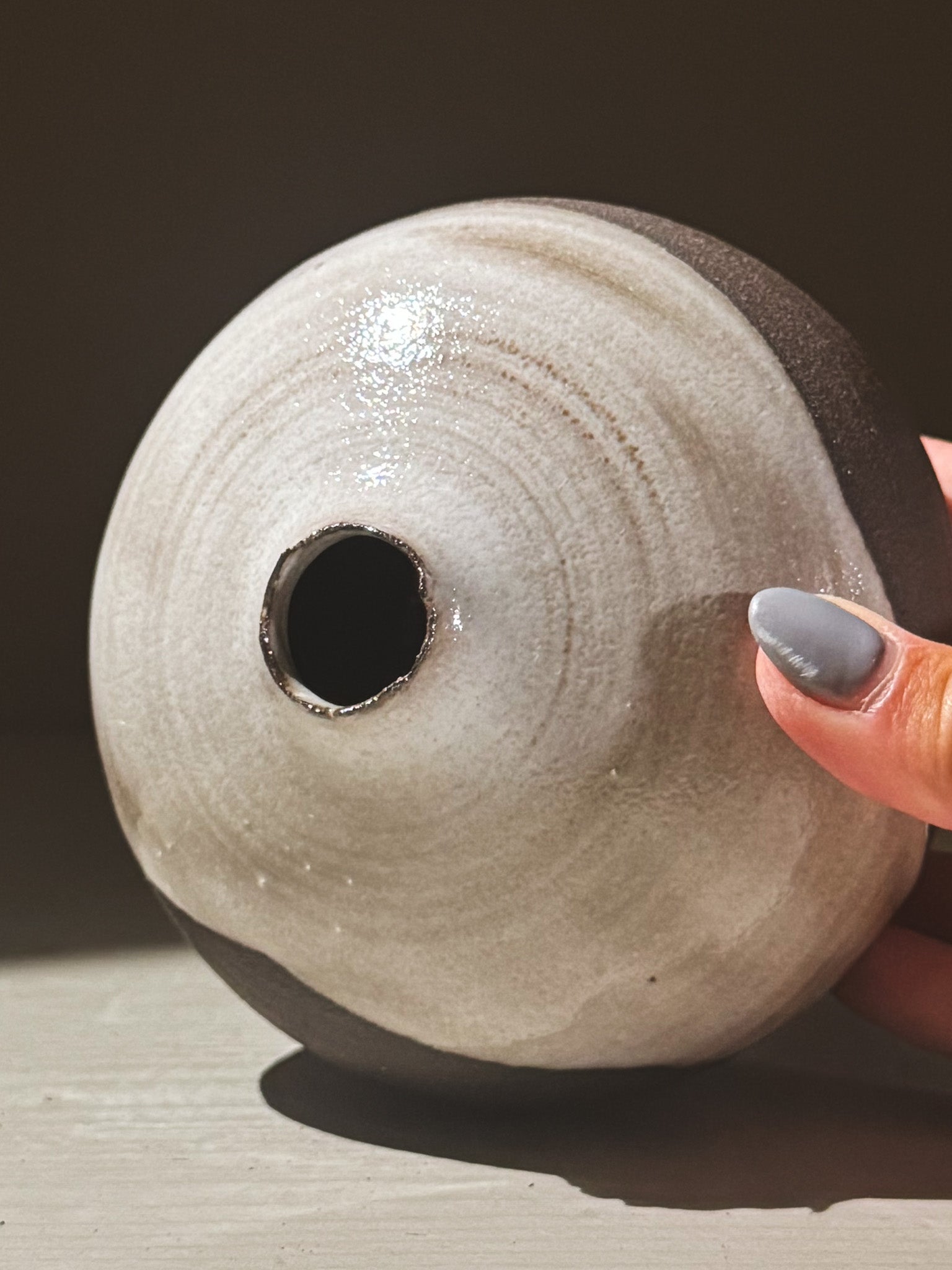 Orb Vase – Yuki Black #08, a rounded vessel with unique glaze patterns and a small opening.
