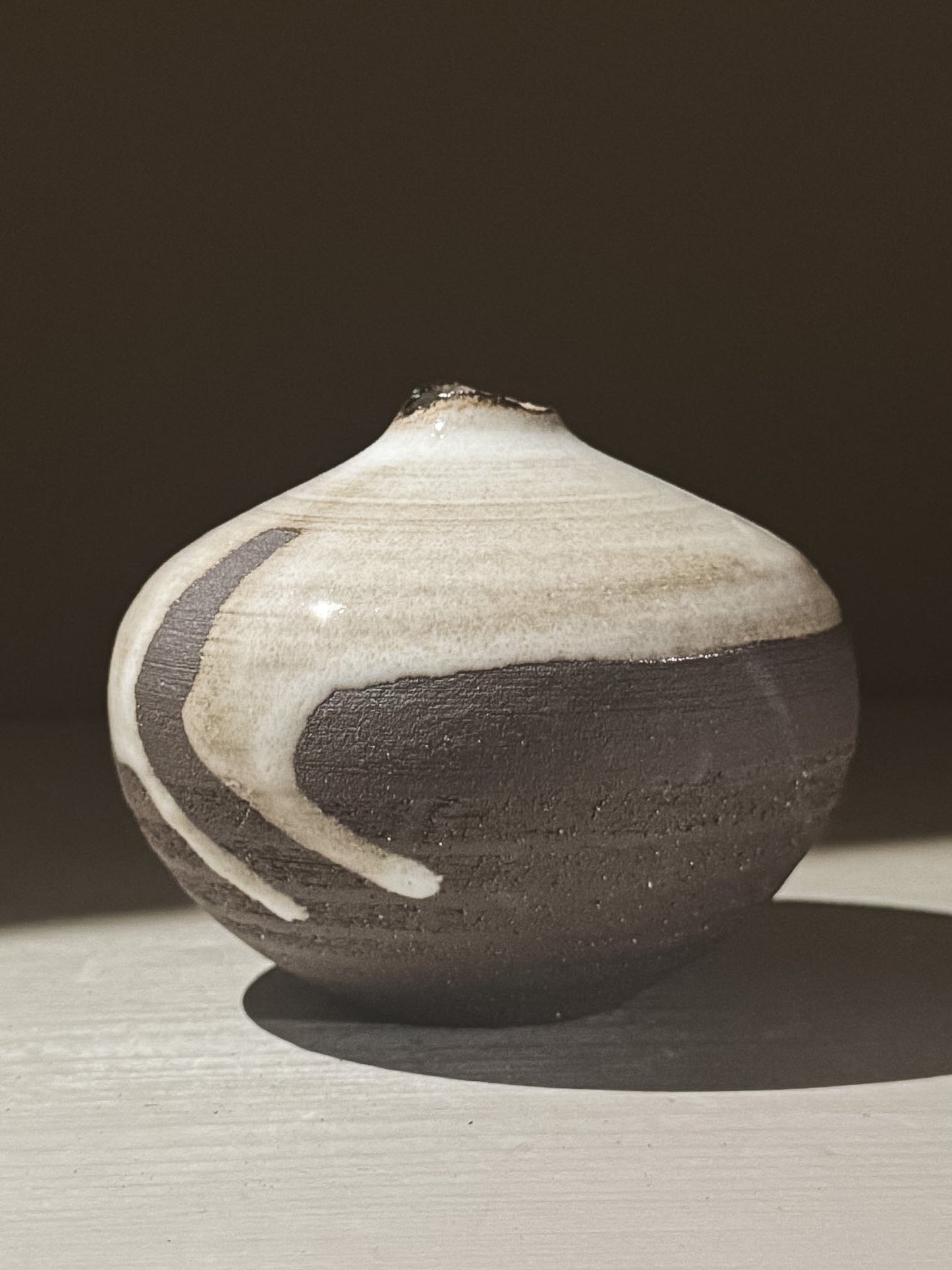 Orb Vase – Yuki Black #09 with unique glaze patterns and soft spherical form, showcasing its artistic design.