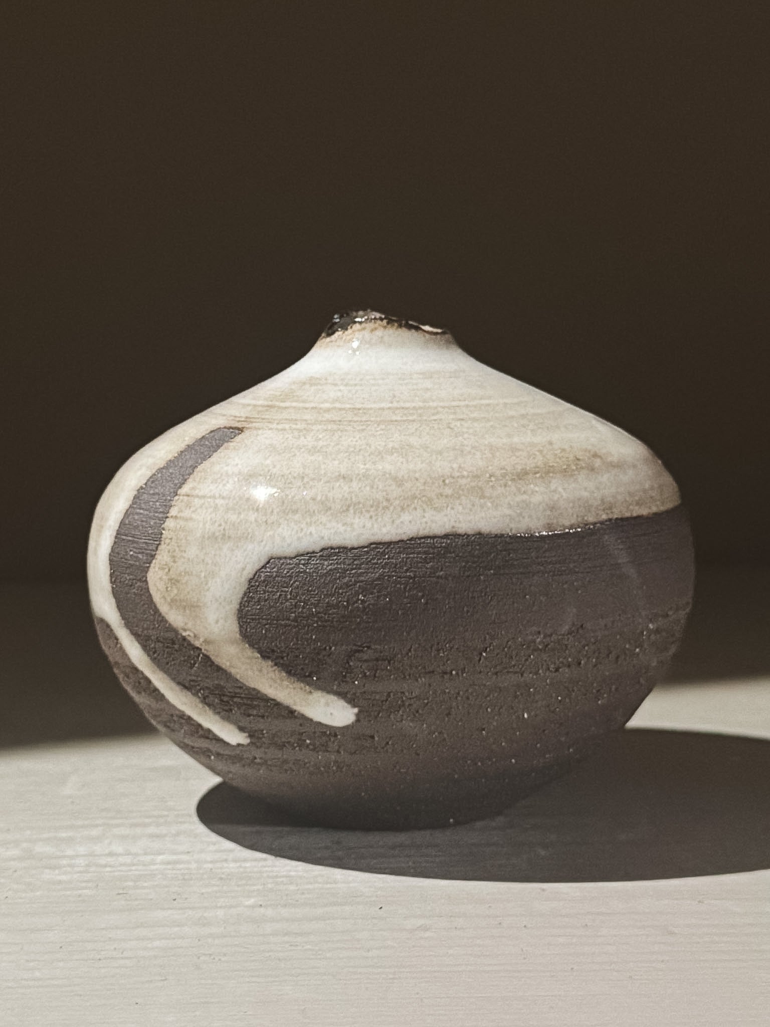 Orb Vase – Yuki Black #09 with unique glaze patterns and soft spherical form, showcasing its artistic design.