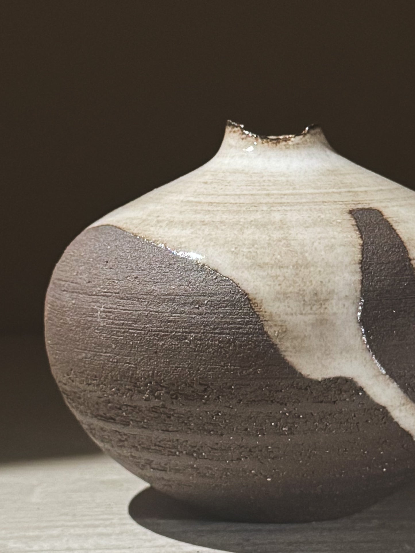 Orb Vase – Yuki Black #09 showcasing unique glaze patterns and soft spherical form in natural light.