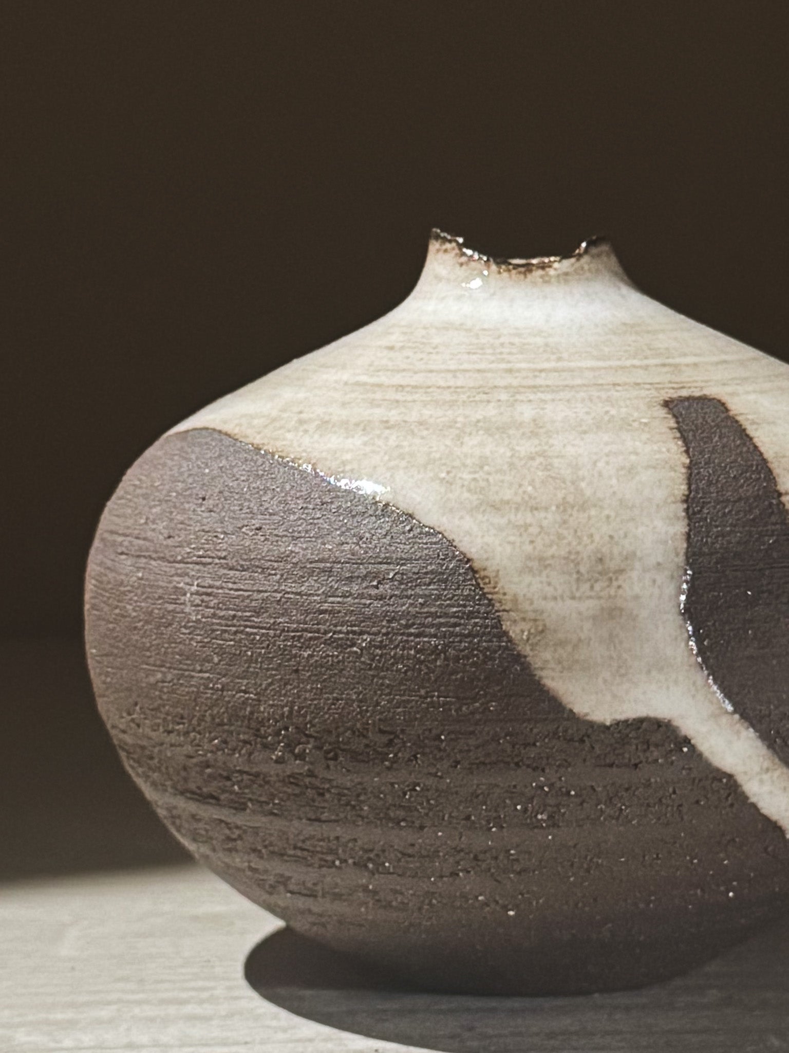 Orb Vase – Yuki Black #09 showcasing unique glaze patterns and soft spherical form in natural light.