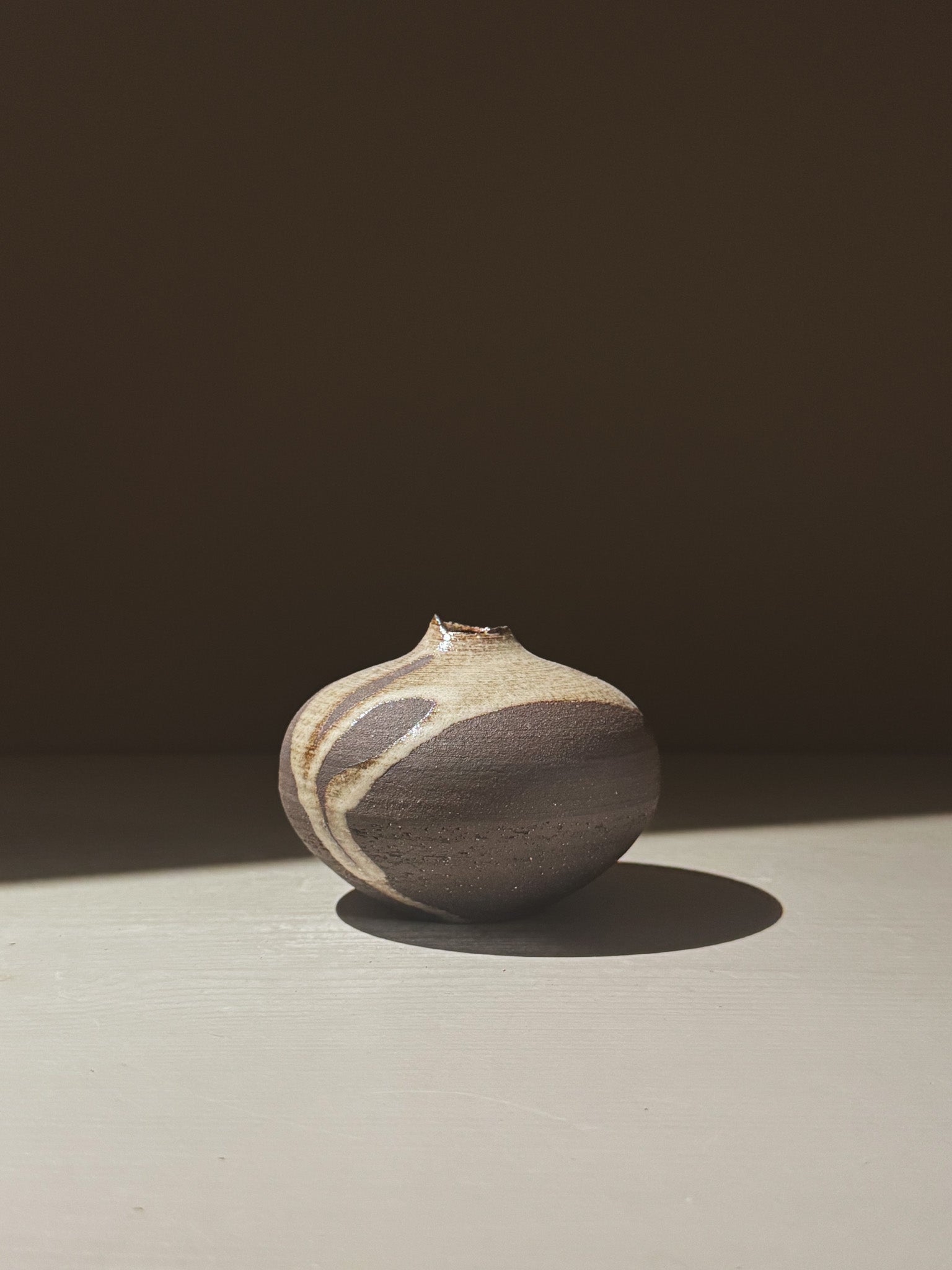 Orb Vase – Yuki Black #10, unique clay vase with organic patterns and gentle glaze movement.