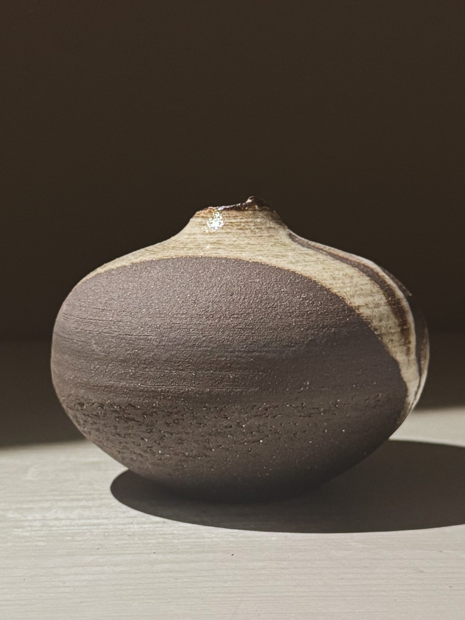 Orb Vase – Yuki Black #10 showcasing a unique rounded design and organic glaze patterns.