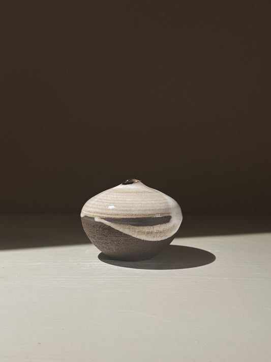 Orb Vase – Yuki Black #11 with unique glaze patterns and soft spherical form, showcasing a serene sculptural presence.