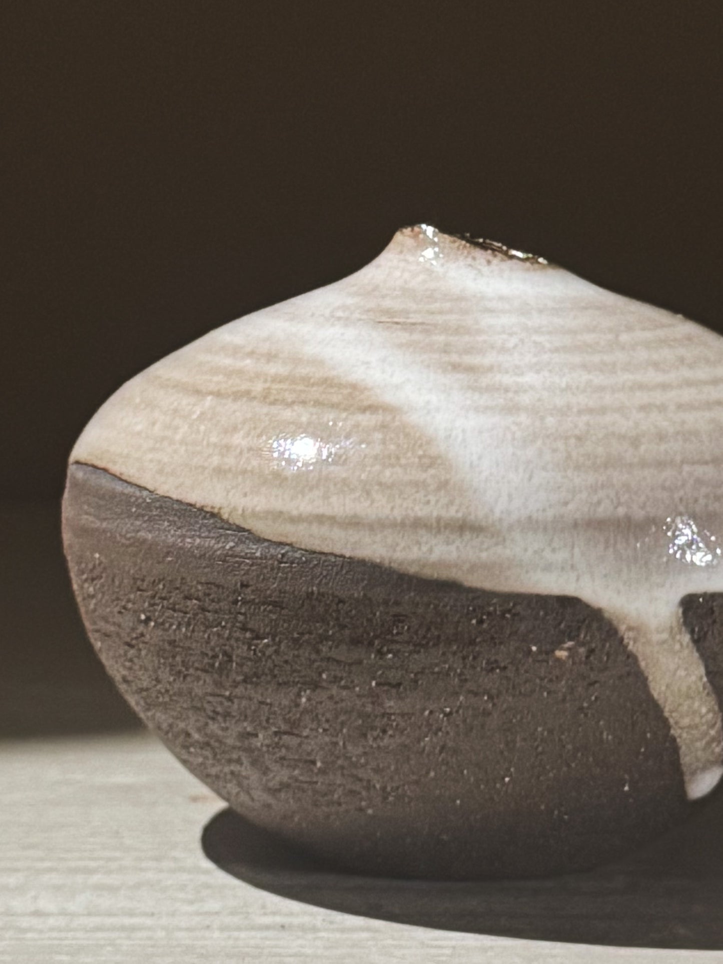 Orb Vase – Yuki Black #11 with unique glaze patterns and a rounded form, showcasing its sculptural presence.